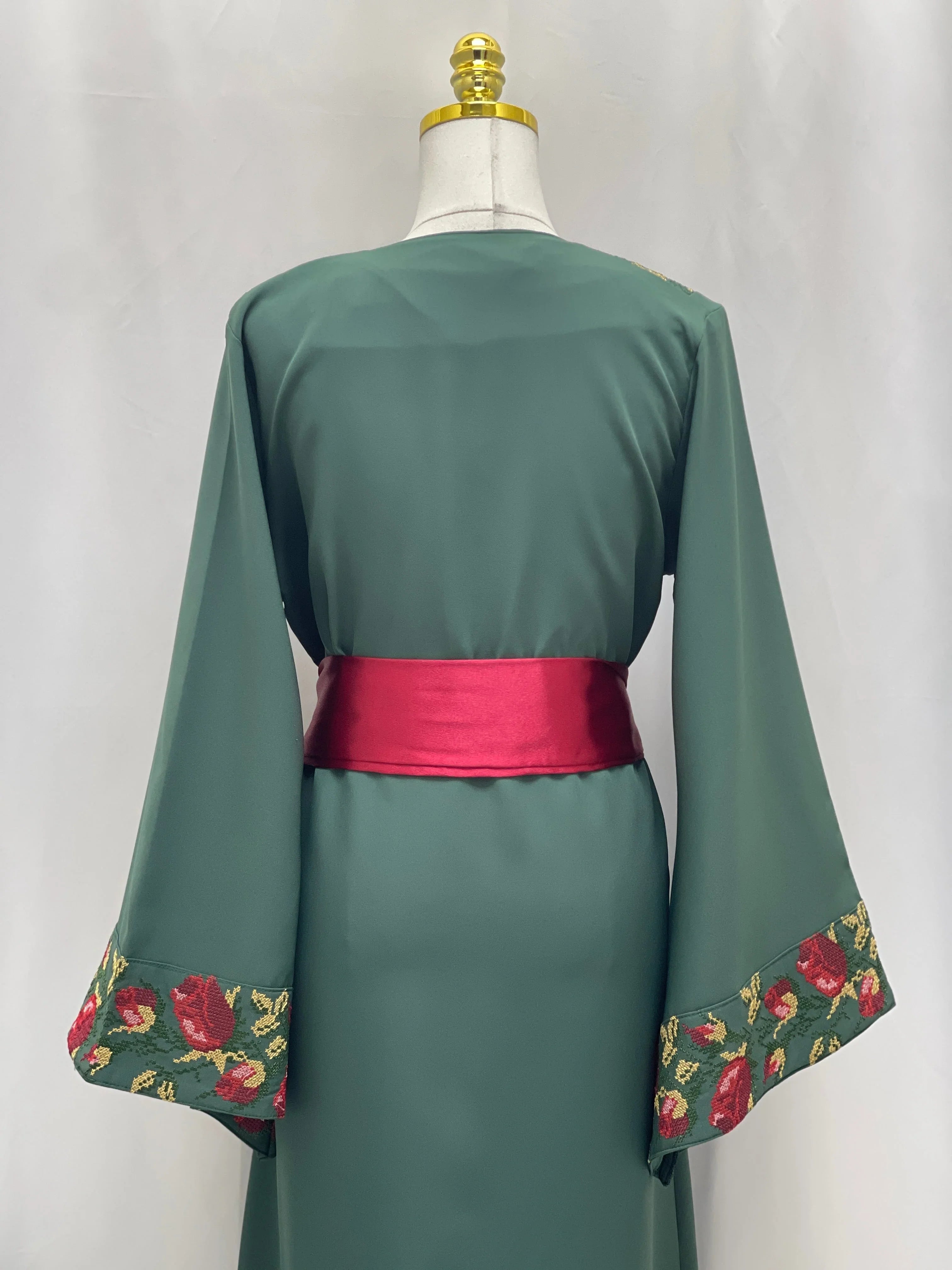 Palestinian Elegance Emerald Blossom EmbroideredThobe back view emerald thobe with red sash and floral sleeve embroidery