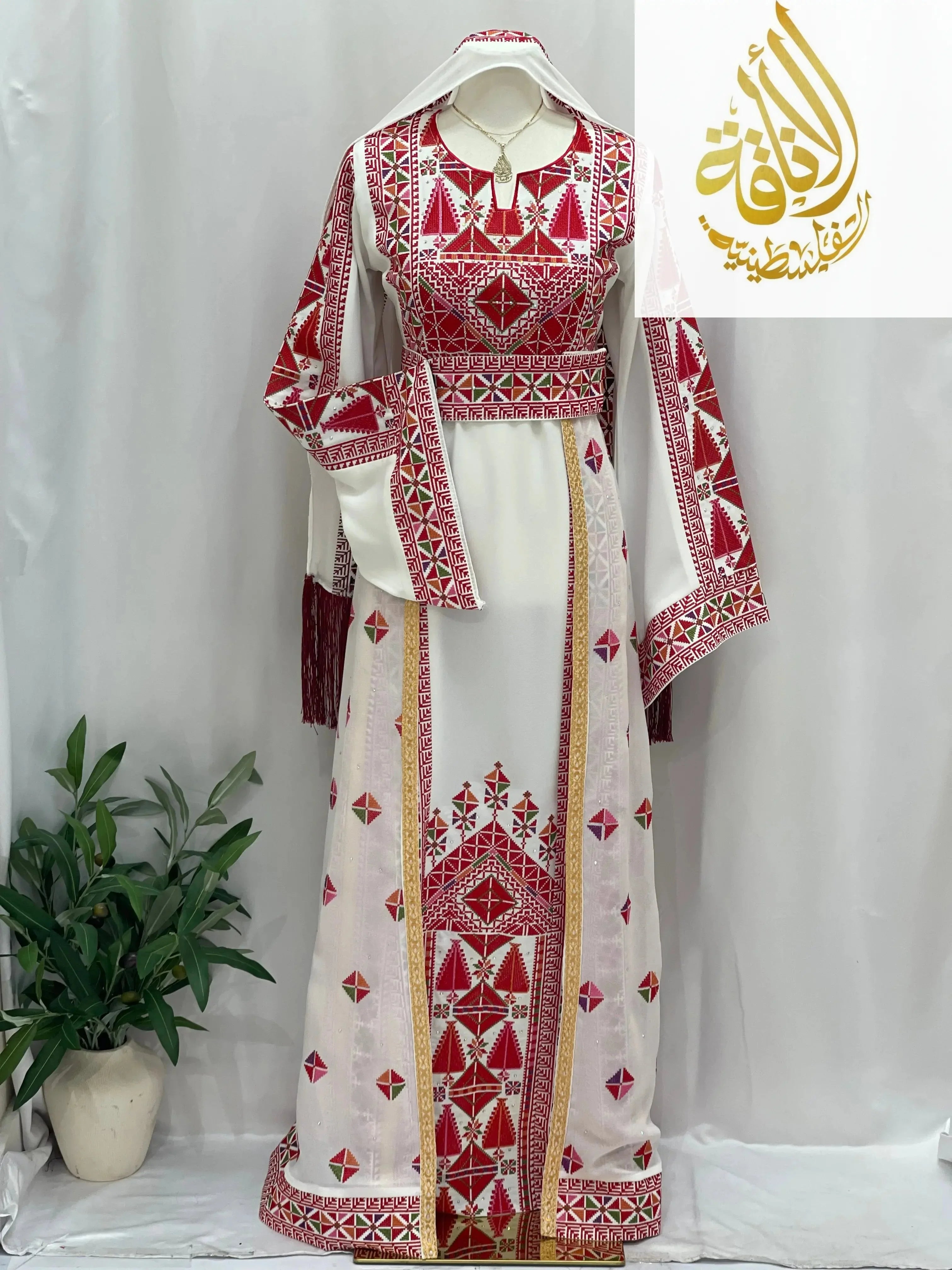 Embroidered Falahi thoub with overskirt by Palestinian Elegance in white and red traditional design
