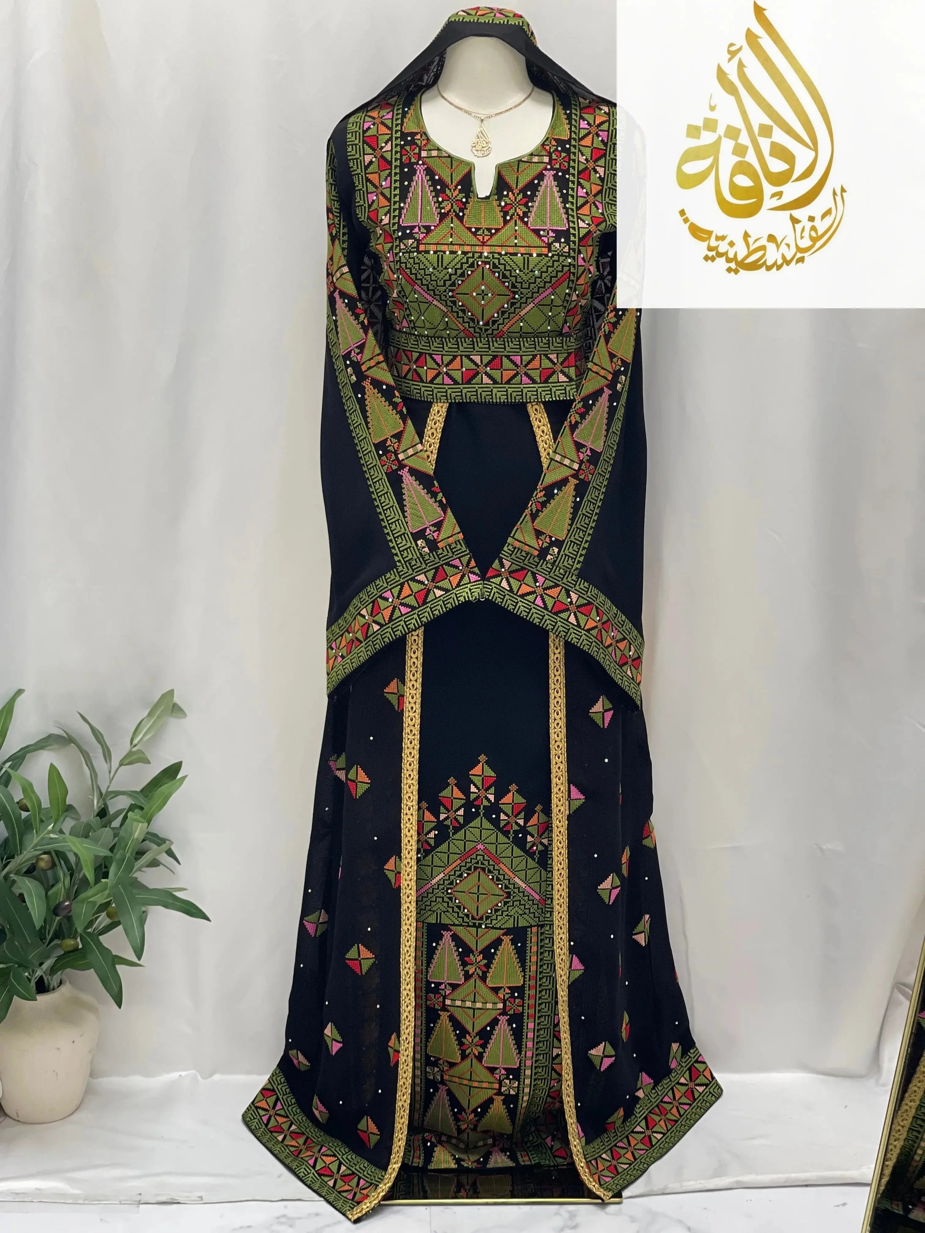 Embroidered Falahi thoub with overskirt in black with green and red traditional Palestinian designs