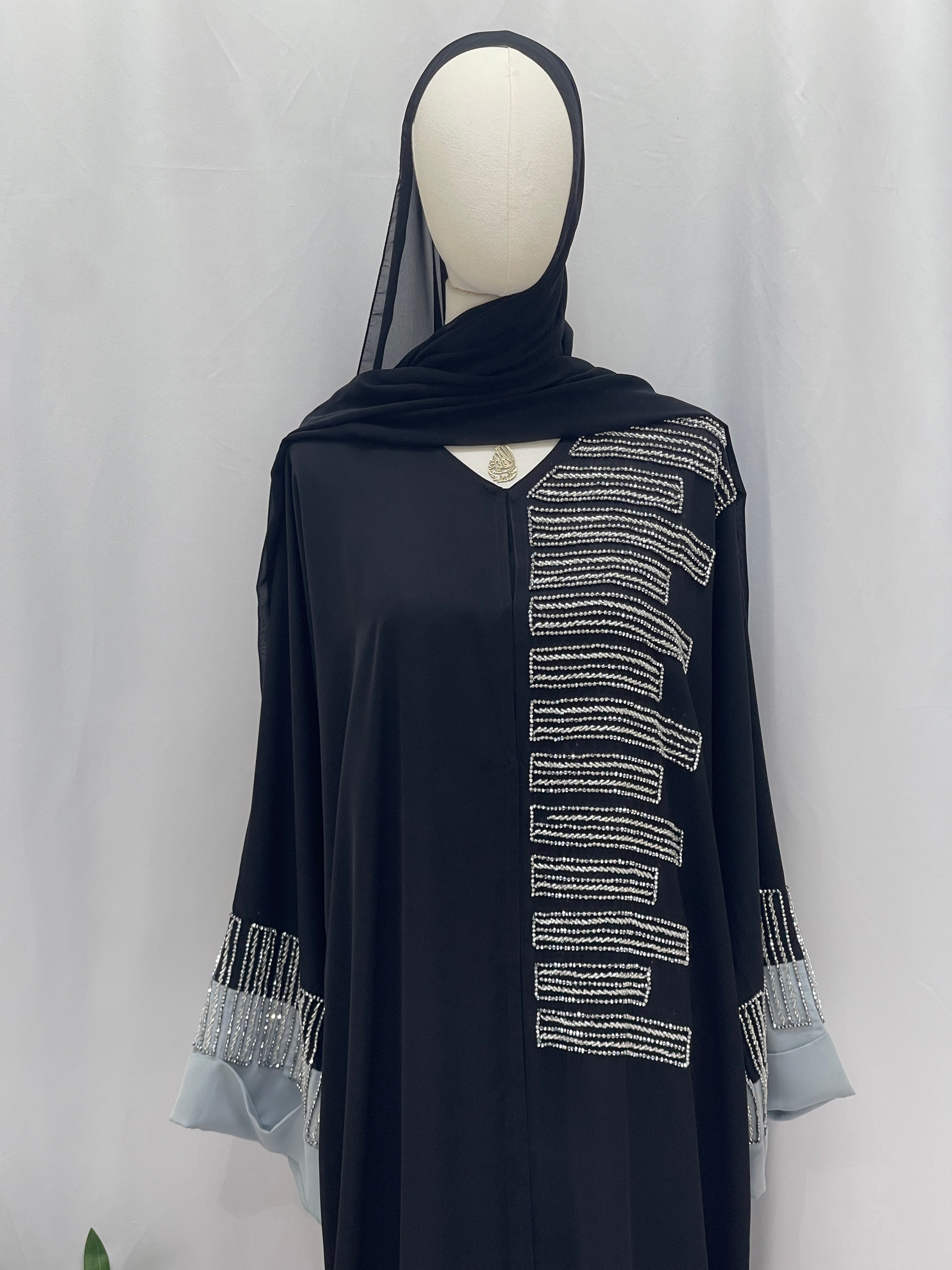 Palestinian Elegance Fancy Beads Dubai Abaya black flowing abaya with vertical silver bead embellishments and beaded cuff details