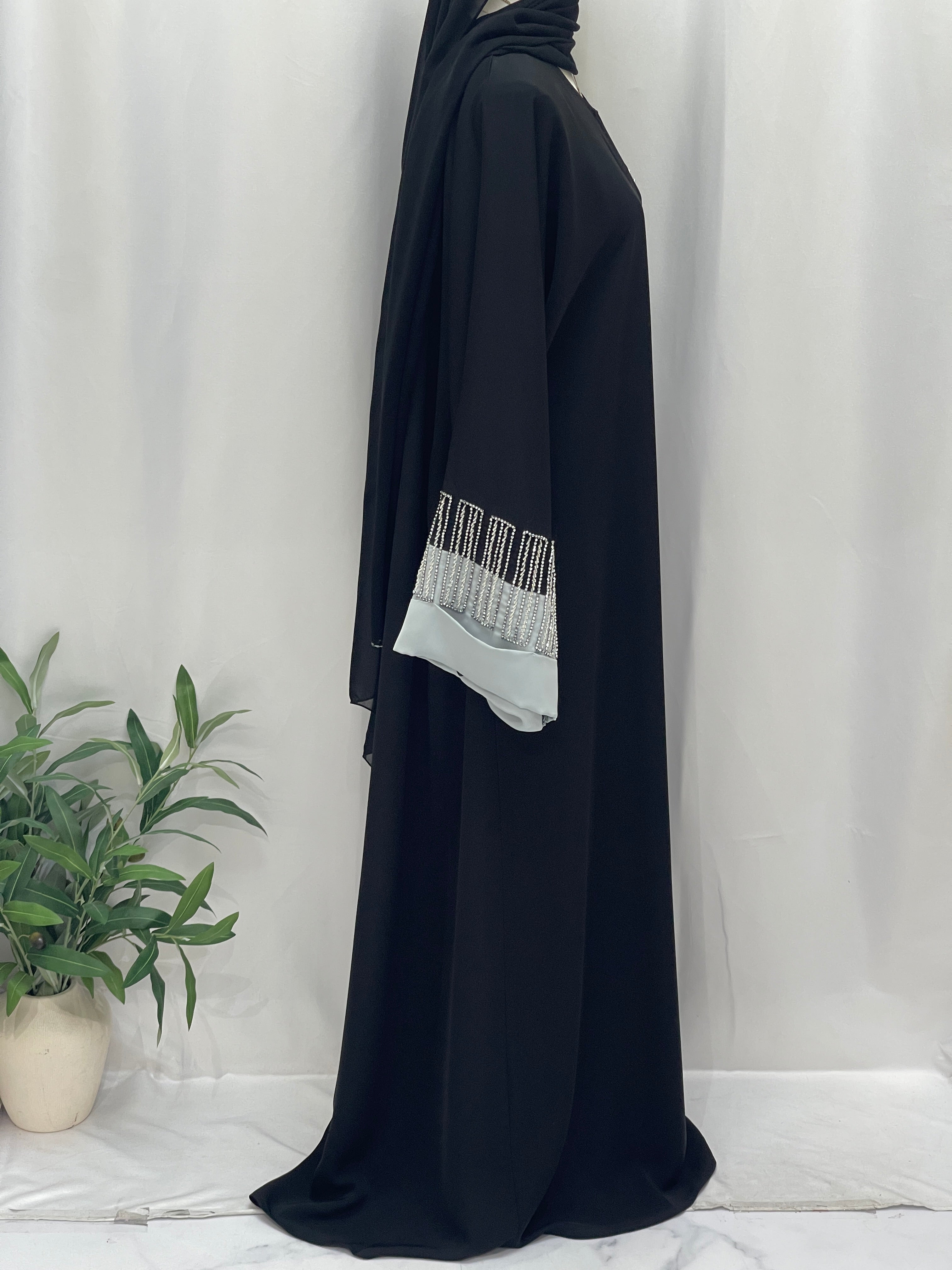 Palestinian Elegance black abaya side view with white beaded cuff detail Fancy Beads Dubai Abaya elegant modest wear