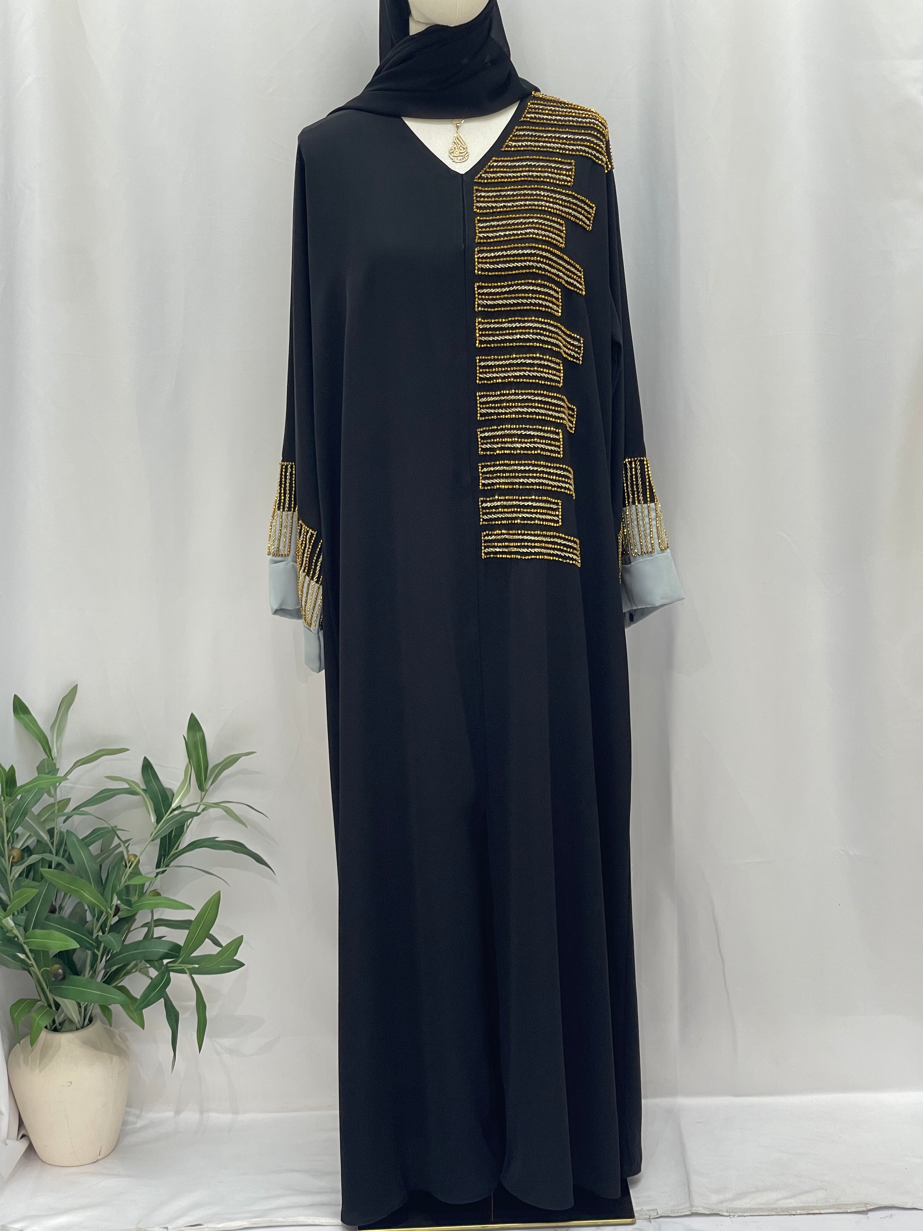 Palestinian Elegance black abaya with gold beaded shoulder and cuff detailing Fancy Beads Dubai Abaya