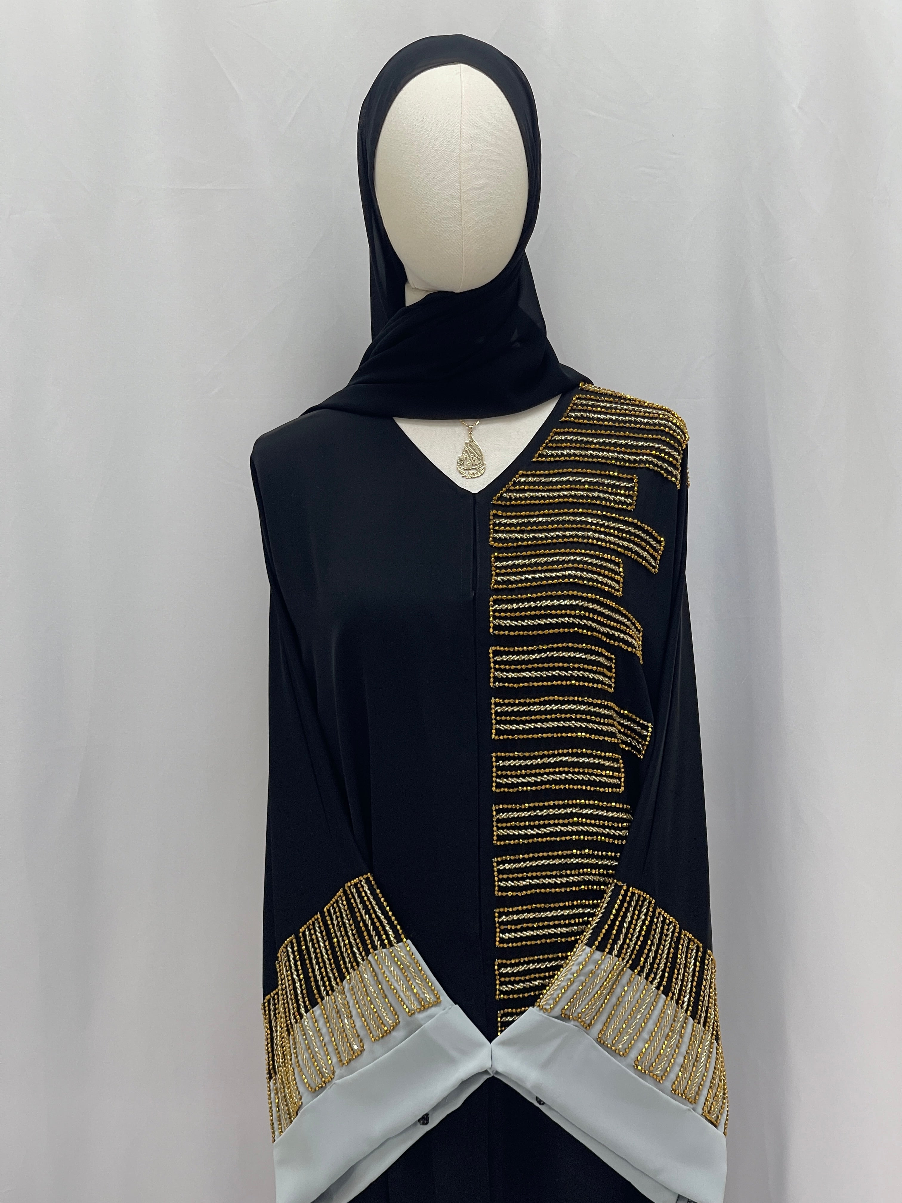 Palestinian Elegance Fancy Beads Dubai Abaya black abaya with gold bead panel and embellished gray cuff sleeves