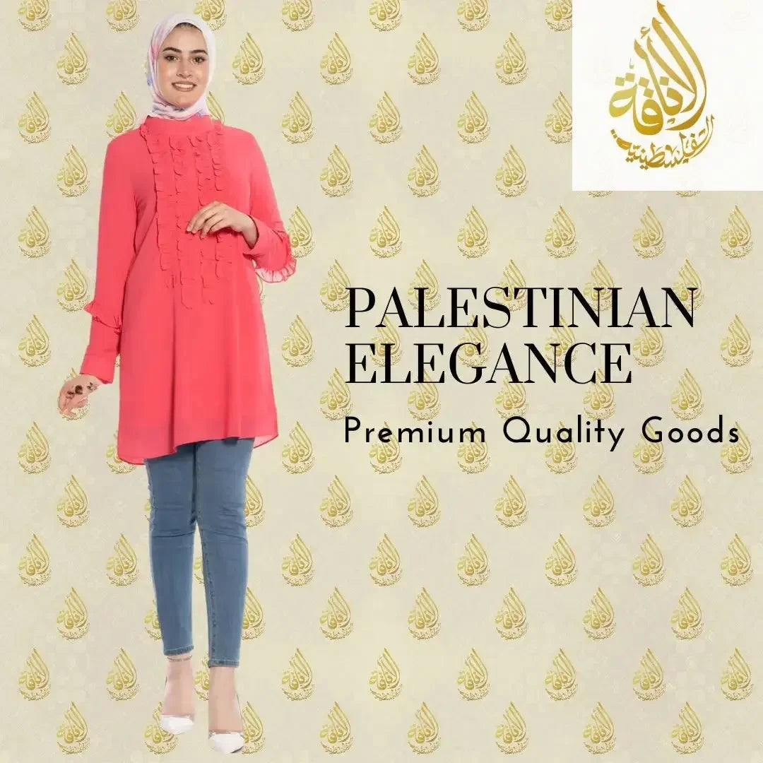 Luxury women's embroidered shirt in coral pink modeled with jeans and white heels by Palestinian Elegance