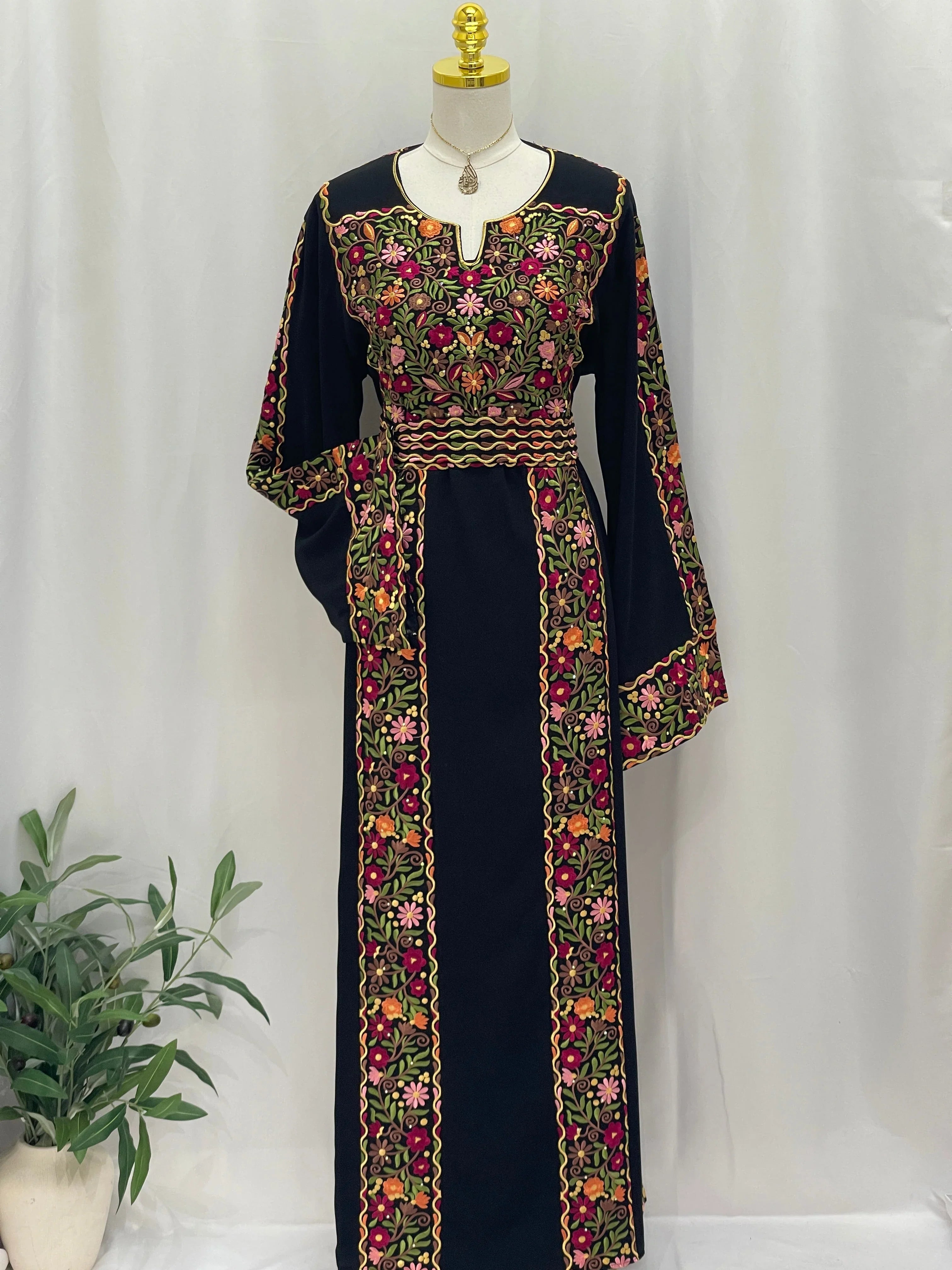 Floral Essence Embroidered Thobe featuring vibrant floral patterns and elegant black fabric