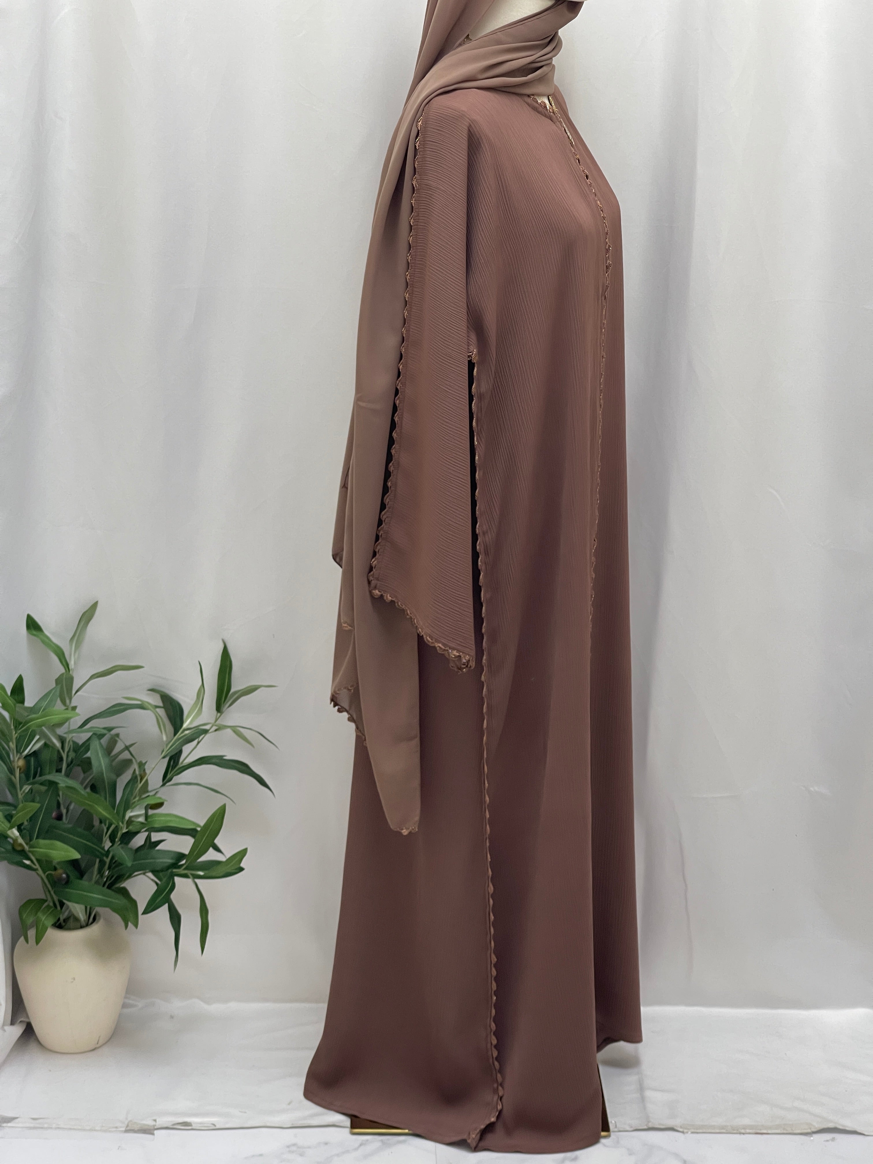 Palestinian Elegance Ghosoon Abaya in brown with detailed trim and flowing fabric styling