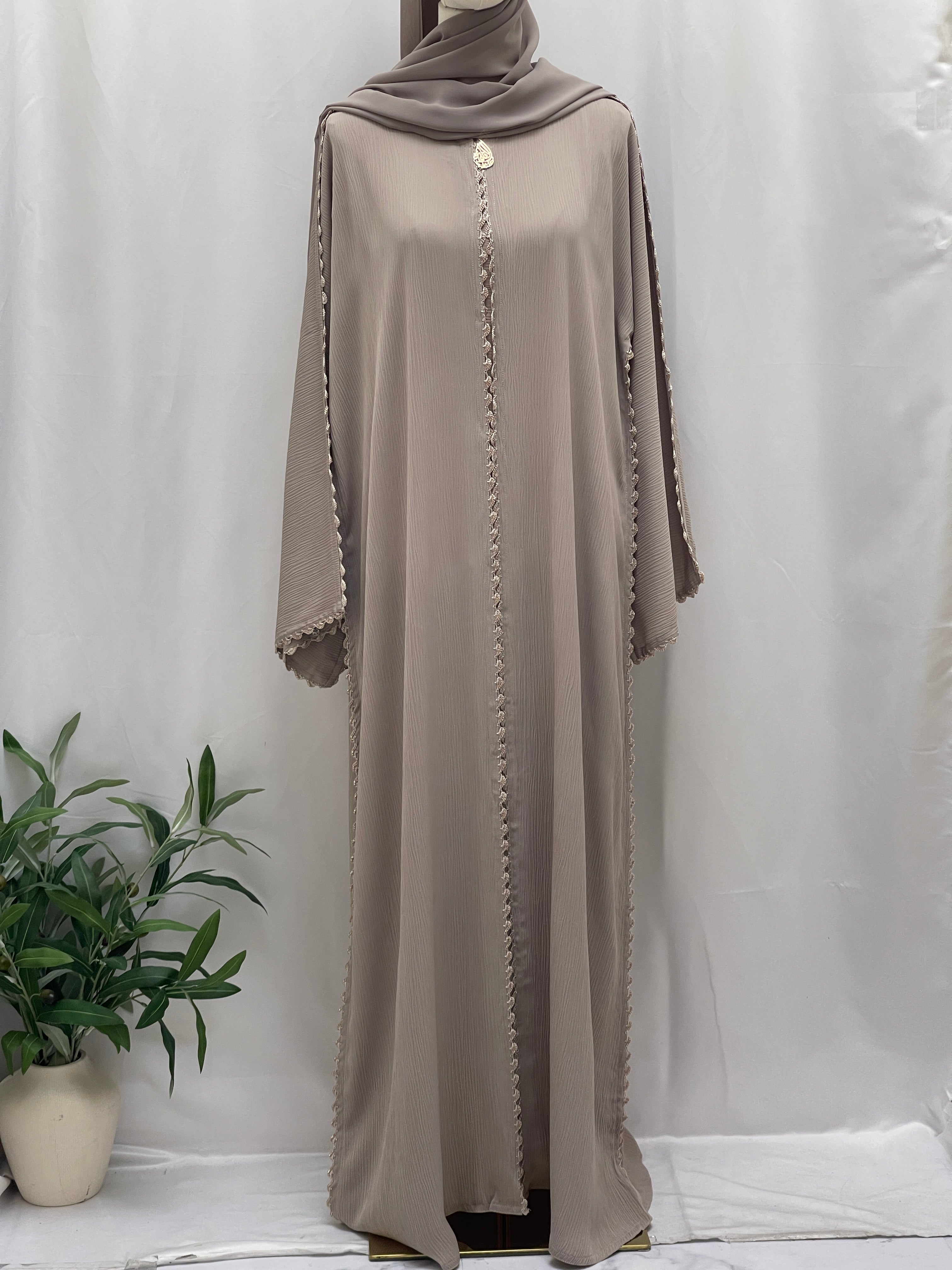 Palestinian Elegance Ghosoon Abaya in soft beige with detailed trim design on sleeves and front