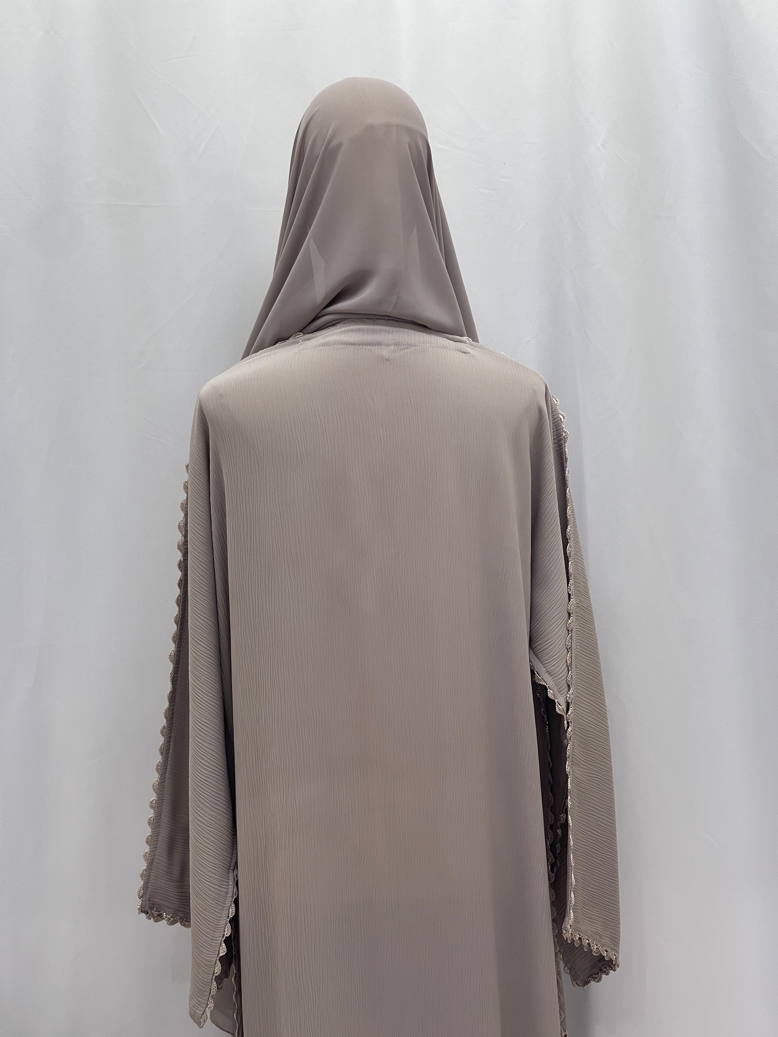 Back view of Palestinian Elegance Ghosoon Abaya in taupe with detailed sleeve trimming and hijab.