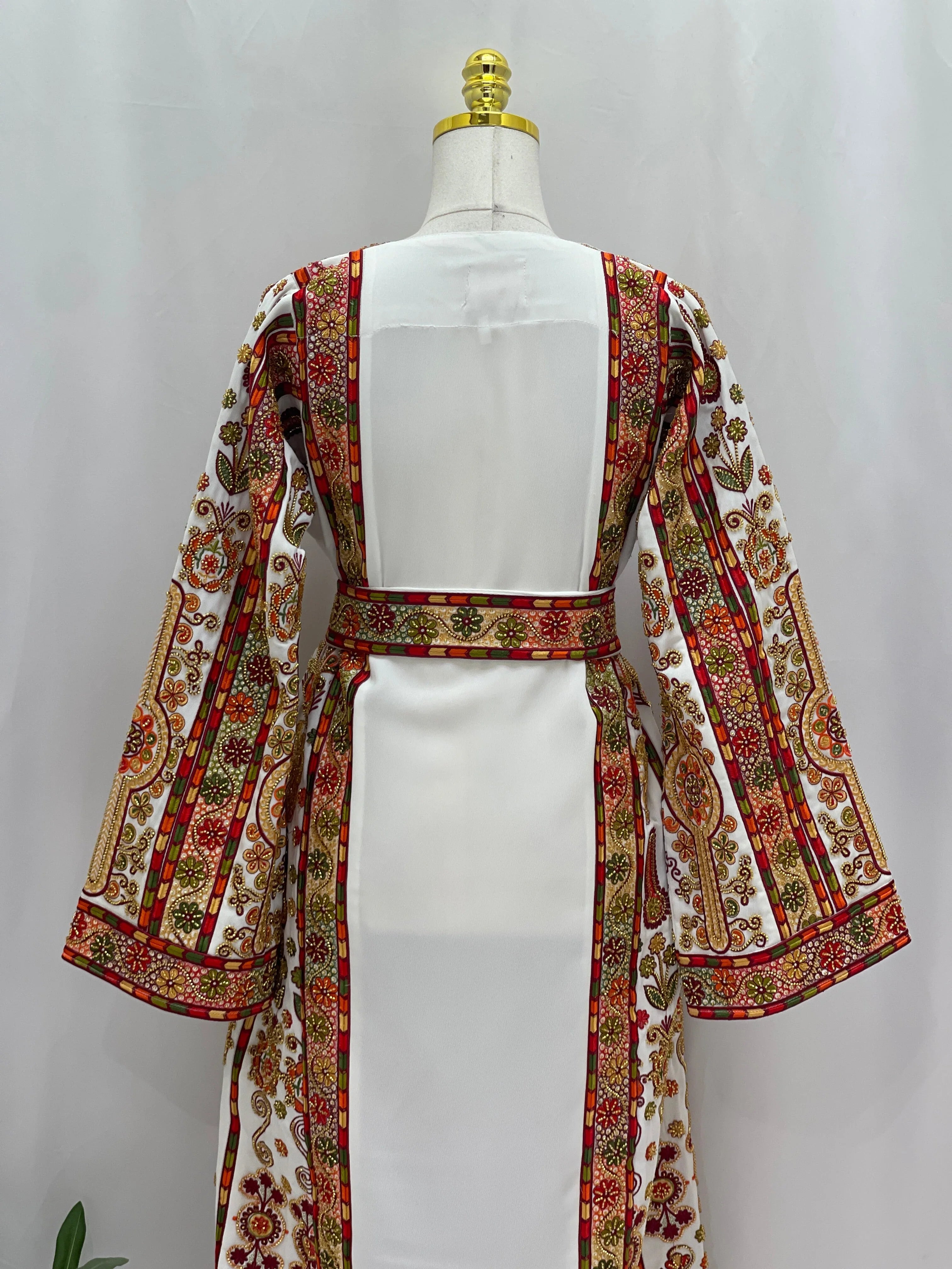 Golden Blossom Beaded Embroidered Thobe back view on mannequin white dress with red and gold floral panels and bell sleeves