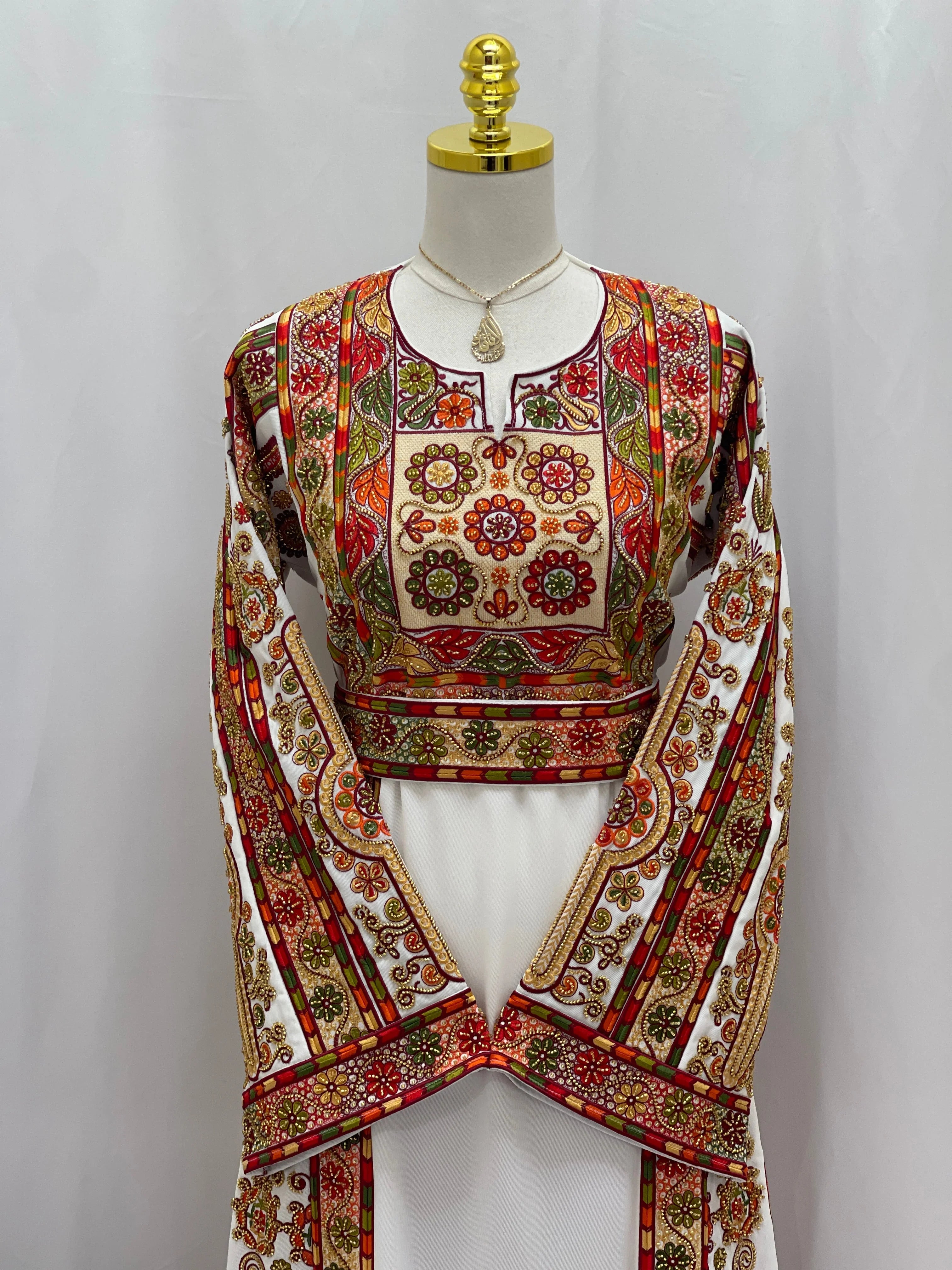 Golden Blossom Beaded Embroidered Thobe by Palestinian Elegance white thobe with gold red floral embroidery and wide sleeves