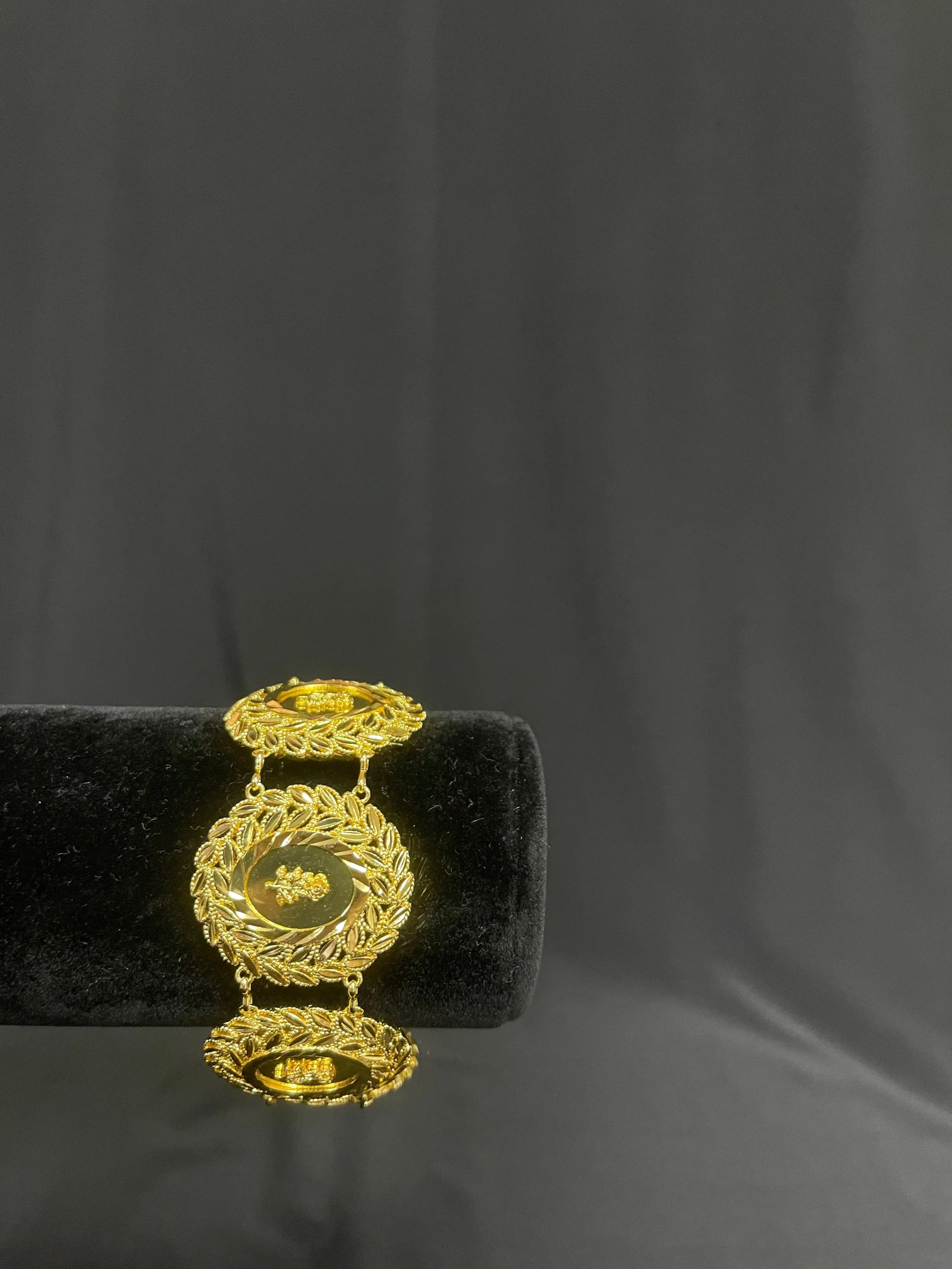 Palestinian Elegance Half Ounce Coin Imitated Gold Bracelet with intricate circular designs on black display