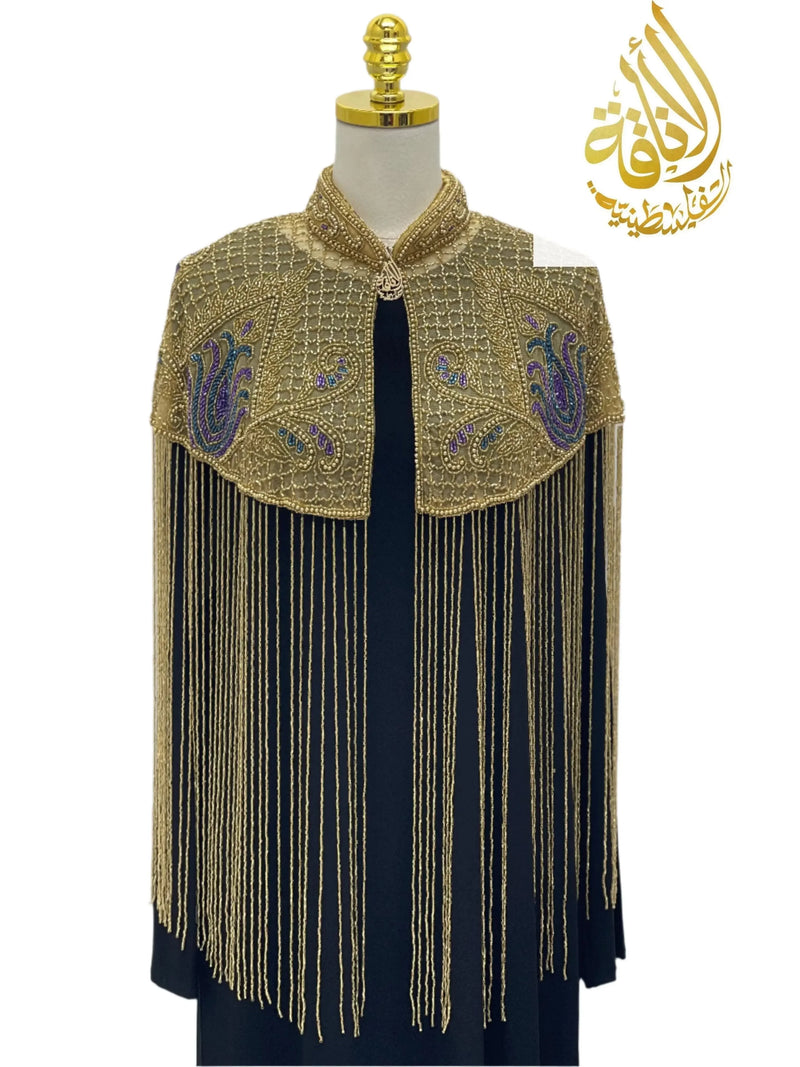 Palestinian Elegance handmade beaded cape with intricate gold beads and fringe detailing over black dress