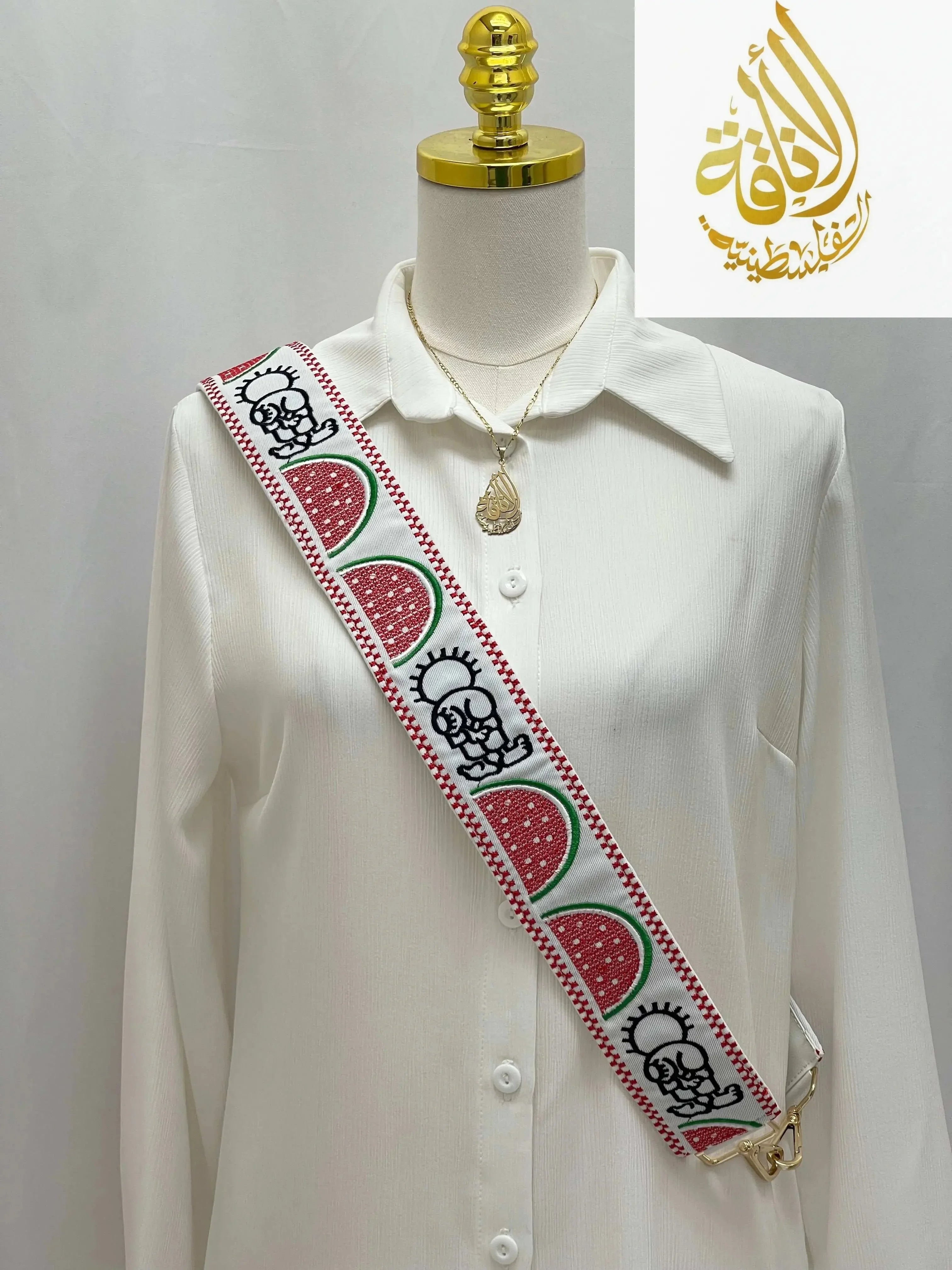 Palestinian embroidered purse strap with red watermelon and traditional motifs on white background