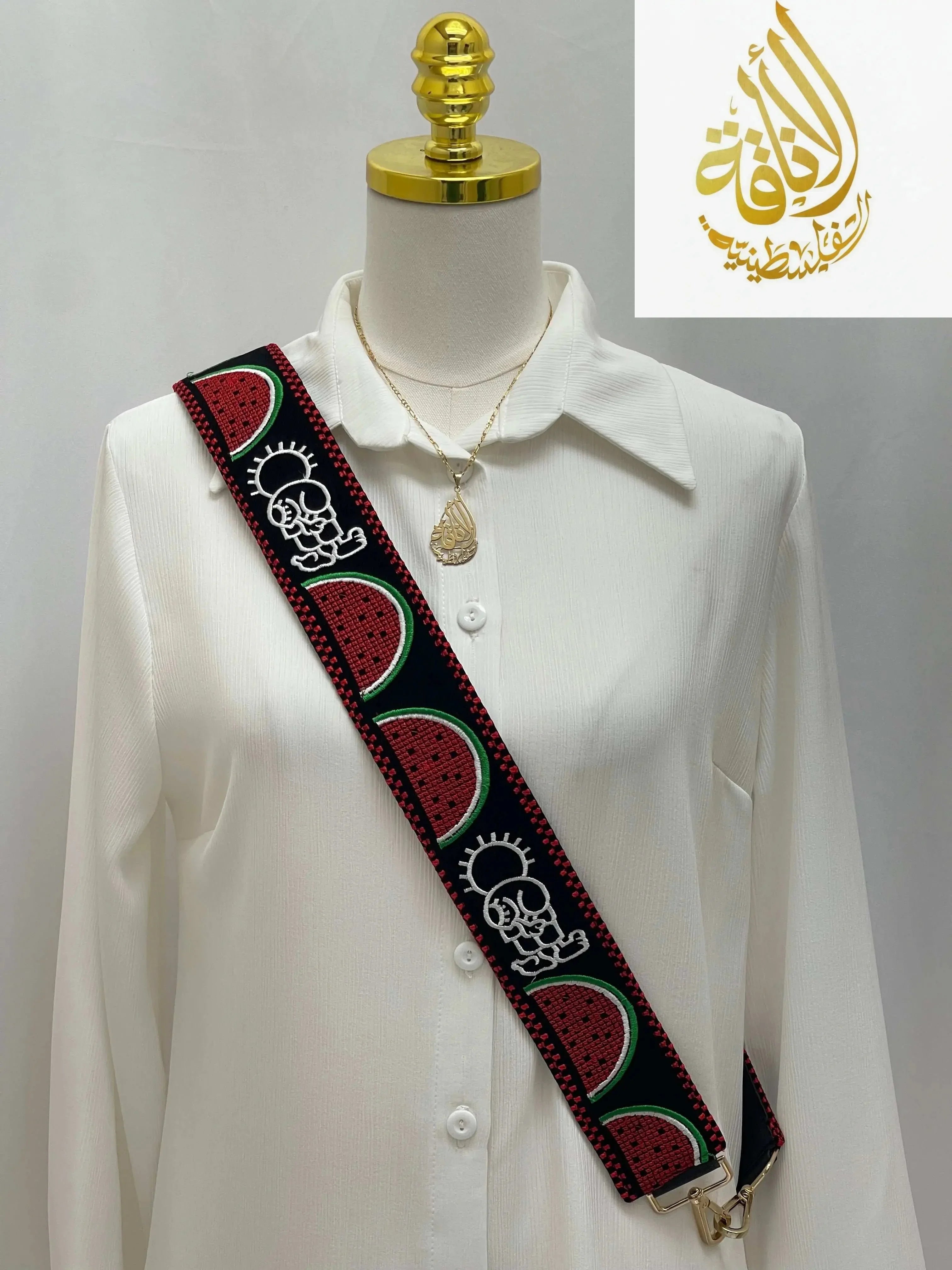 Palestinian embroidered purse strap with colorful watermelon and traditional designs on a white shirt