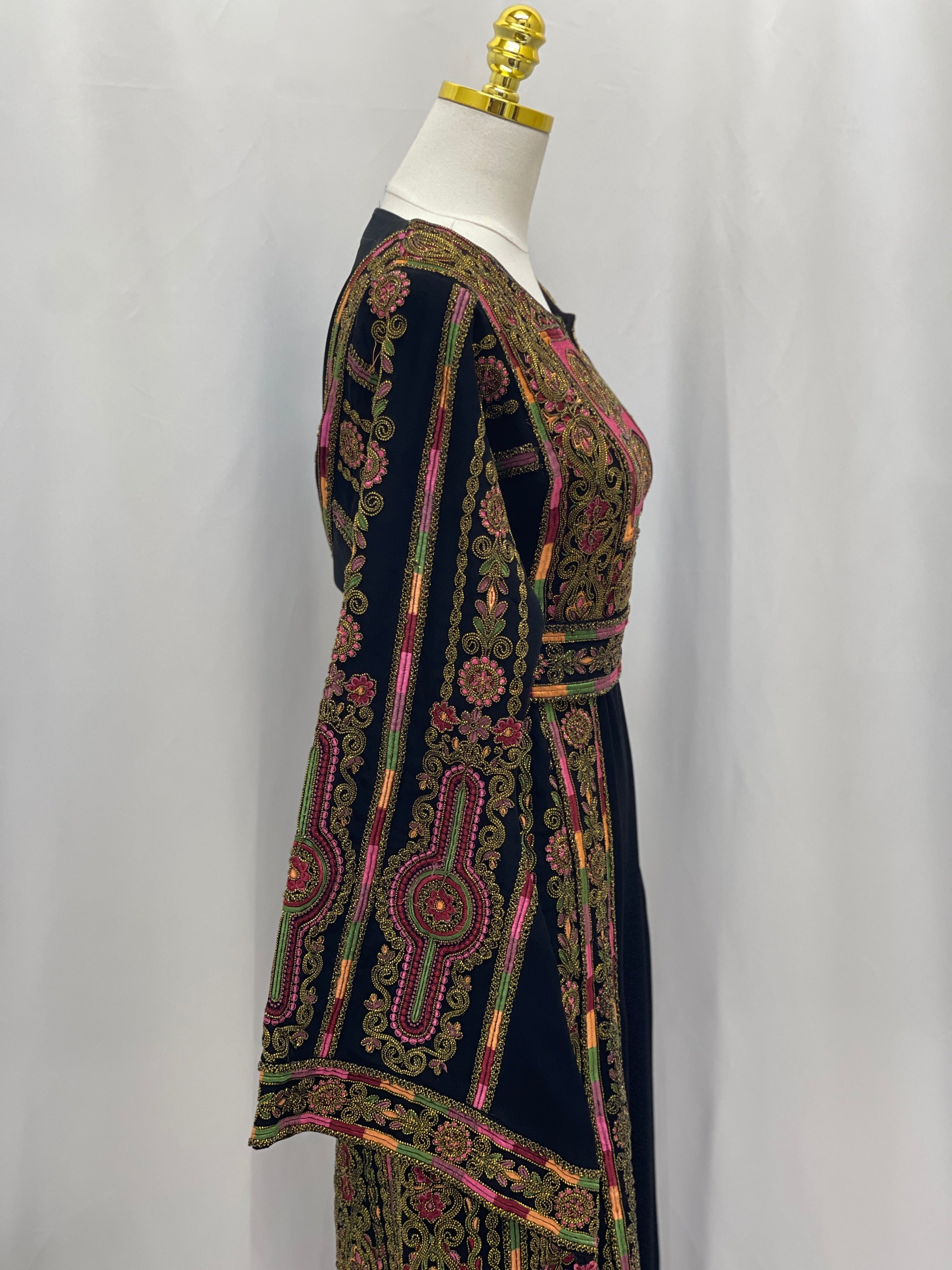 Heritage Glow Bream Embroidered Thoub. Palestinian Elegance black thobe with multicolor tatreez embroidery side view on mannequin