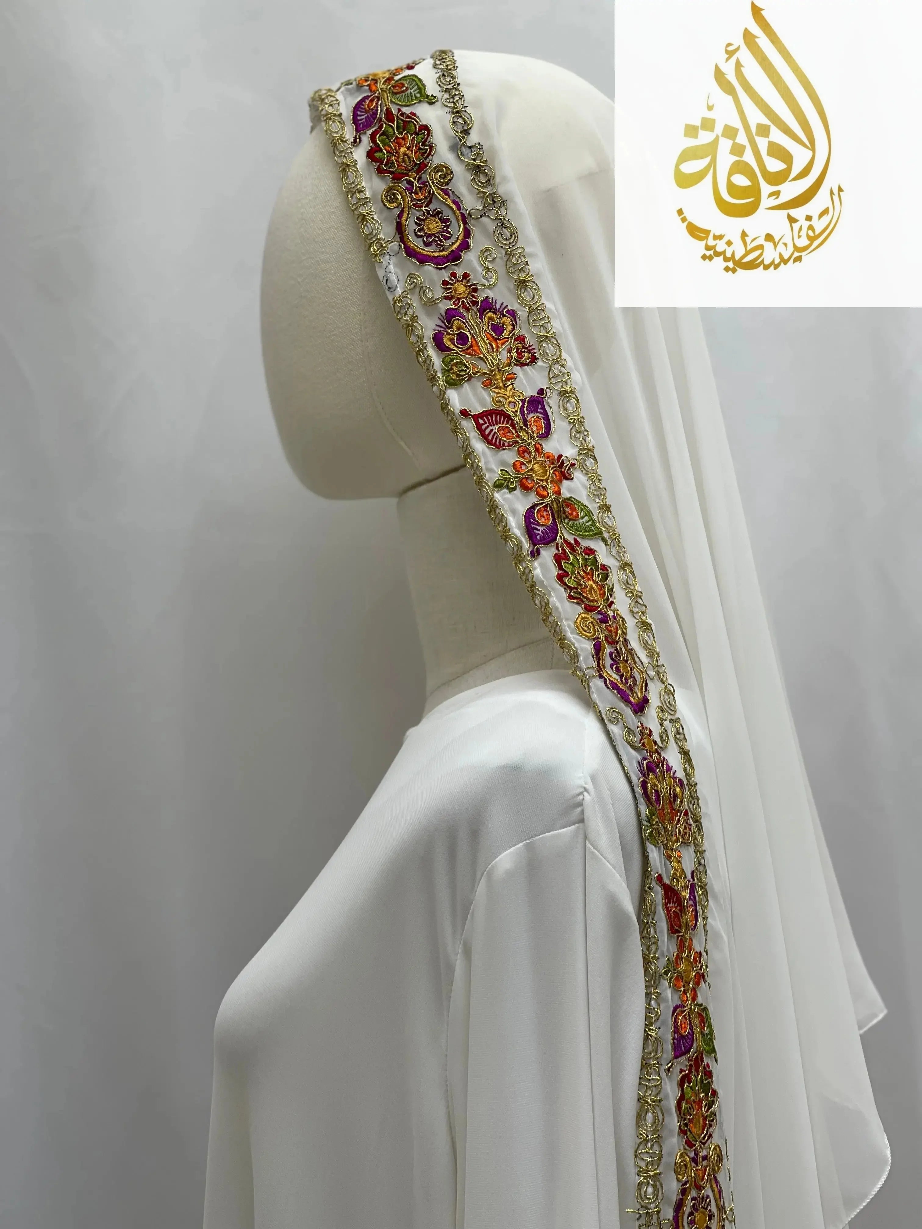 Palestinian Traditional Modest Fashion Kasab Khirka featuring intricate colorful embroidery on white fabric by Palestinian Elegance