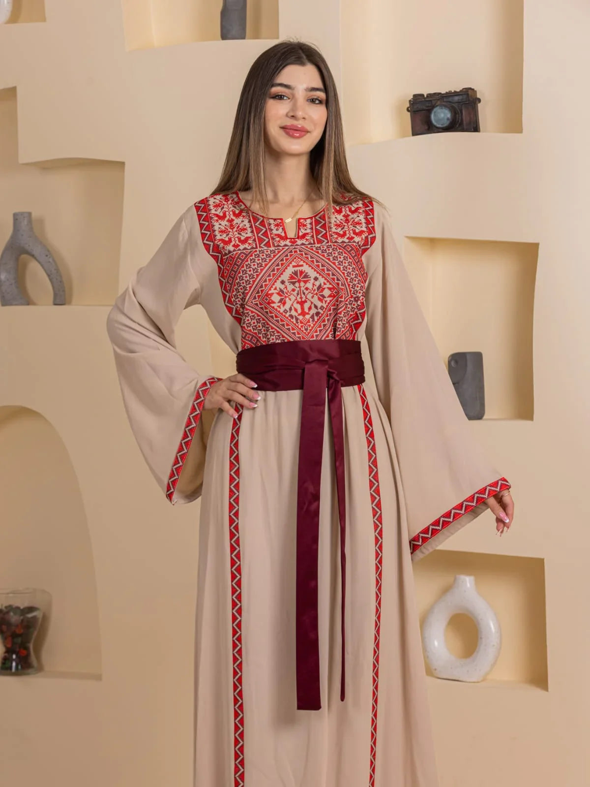 Huda Simply Embroidered Thoub Palestinian Elegance beige thobe with red cross stitch embroidery and maroon sash