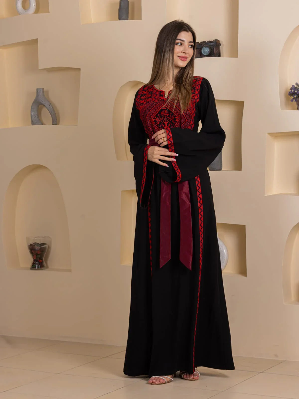 Huda Simply Embroidered Thoub Palestinian Elegance black thobe with red embroidery wide sleeves and waist ties on model