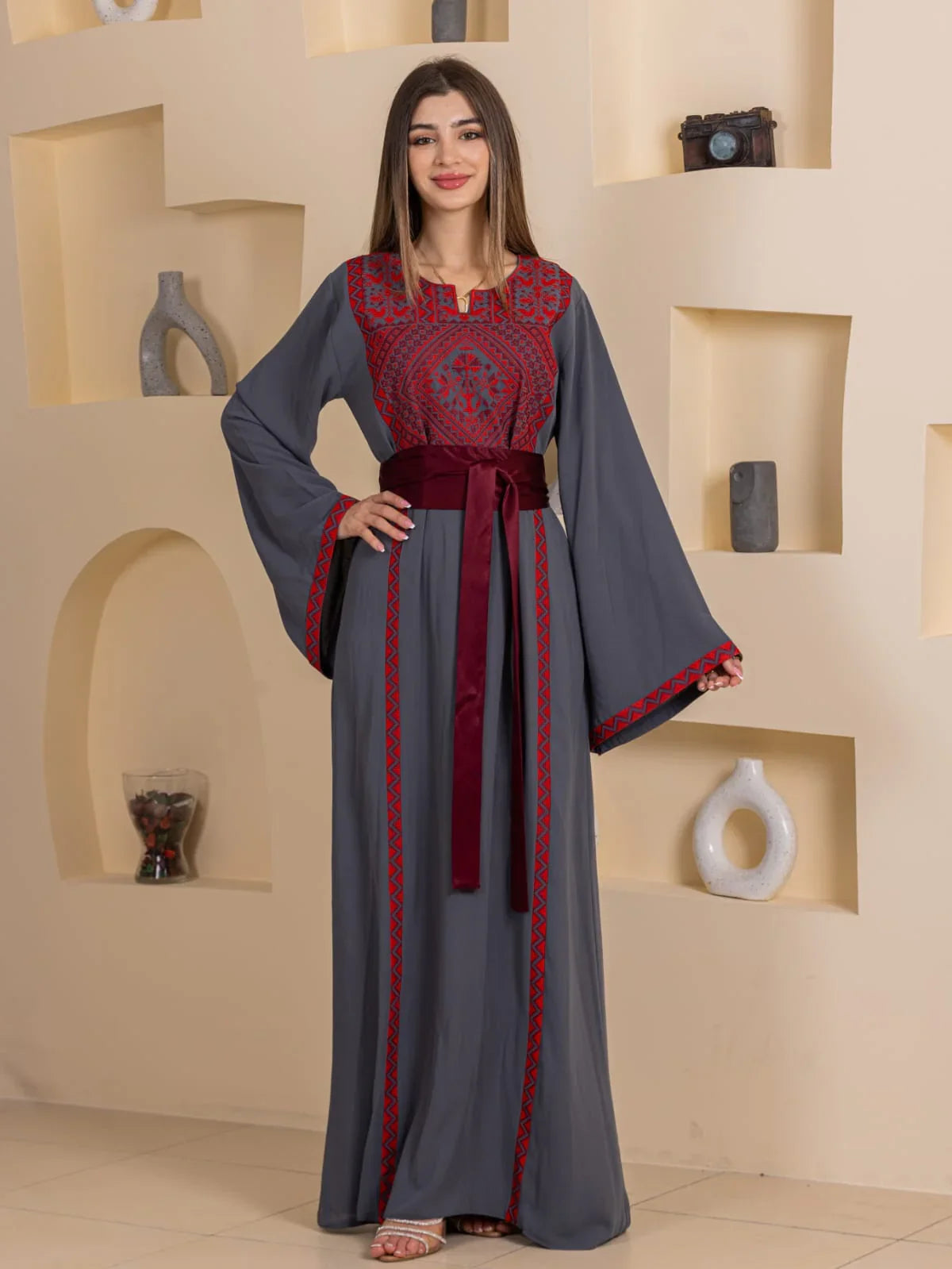 Huda Simply Embroidered Thoub by Palestinian Elegance gray embroidered thobe with red geometric stitching and maroon waist sash