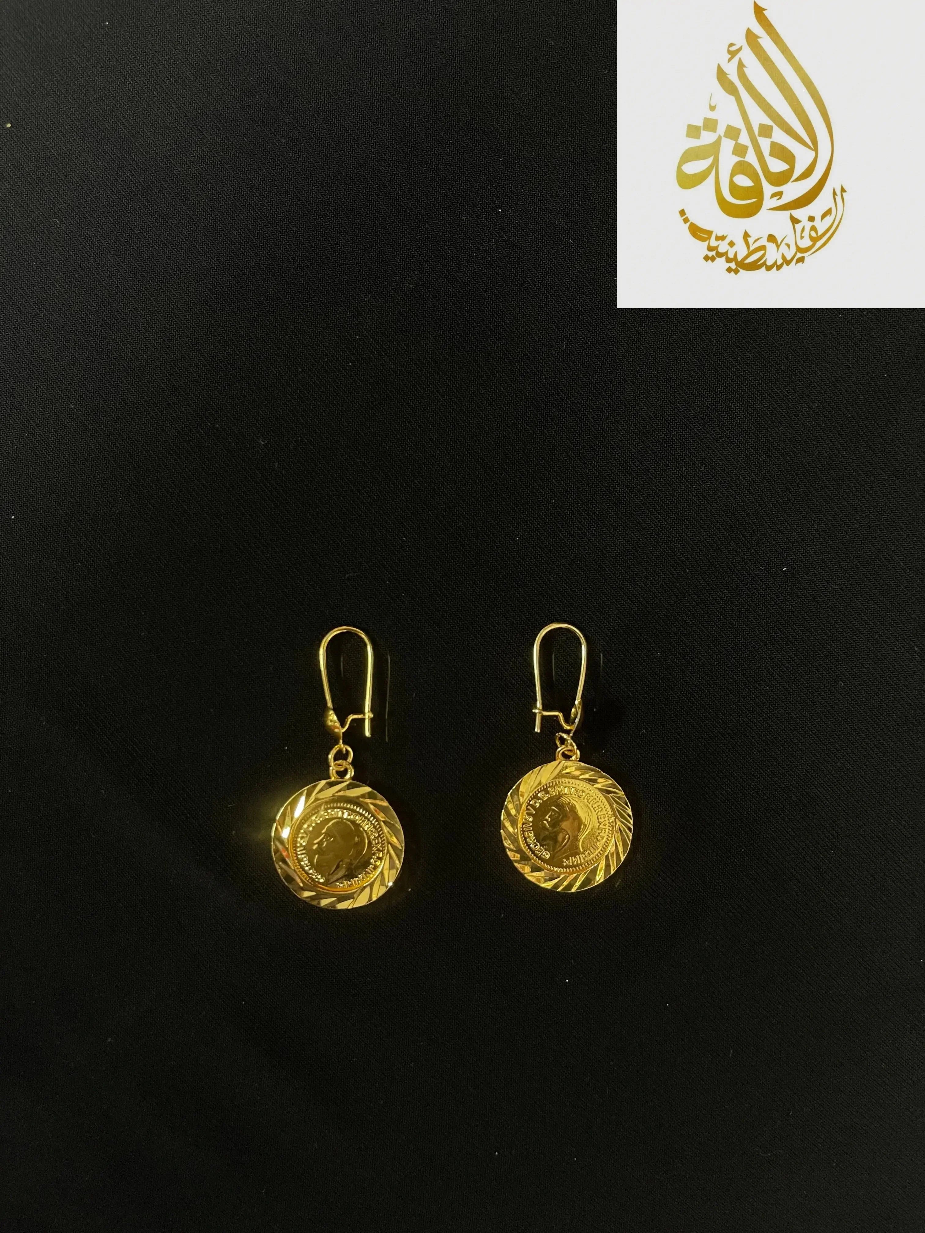 Palestinian Elegance imitated gold earrings with round coin pendant design on black background