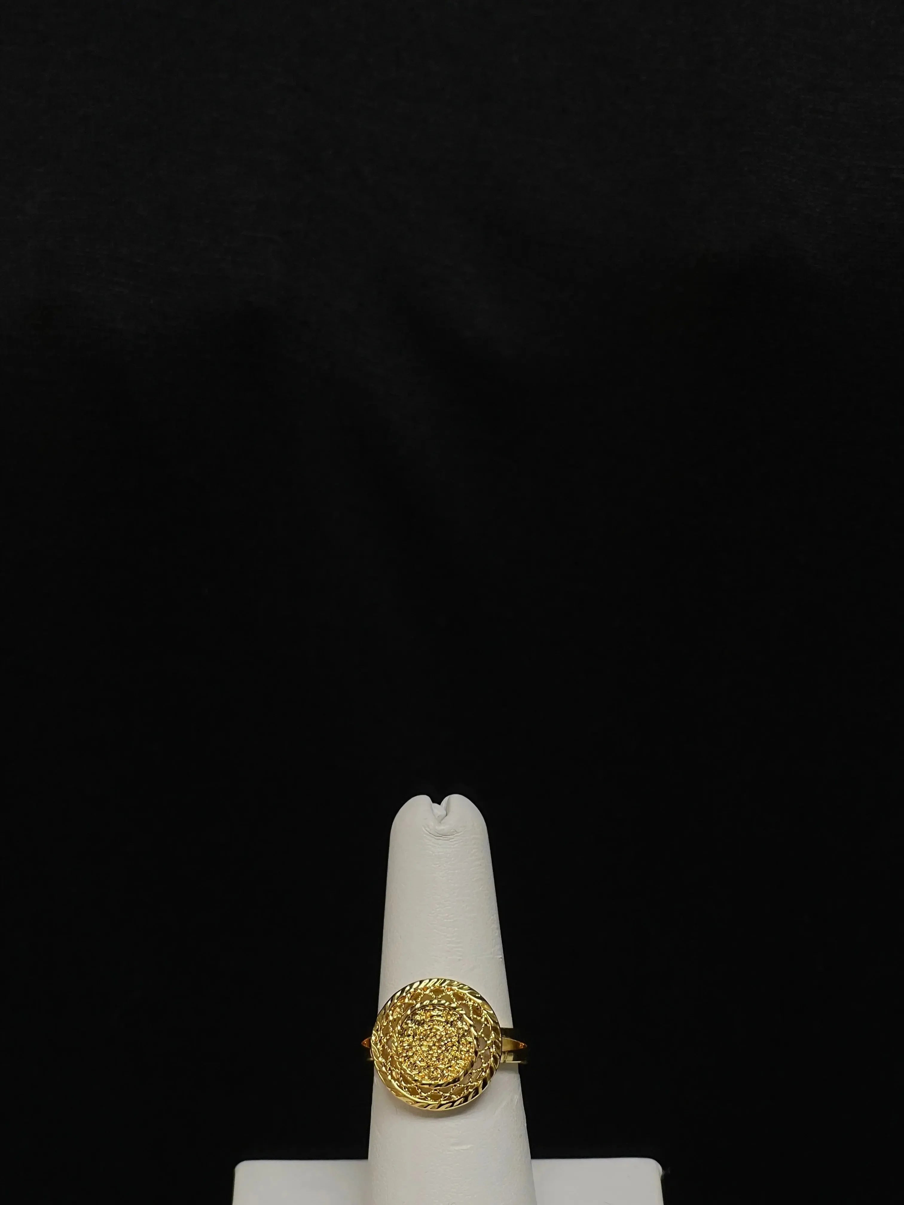 Gold layered necklace set ring with intricate design displayed on a white stand by Palestinian Elegance