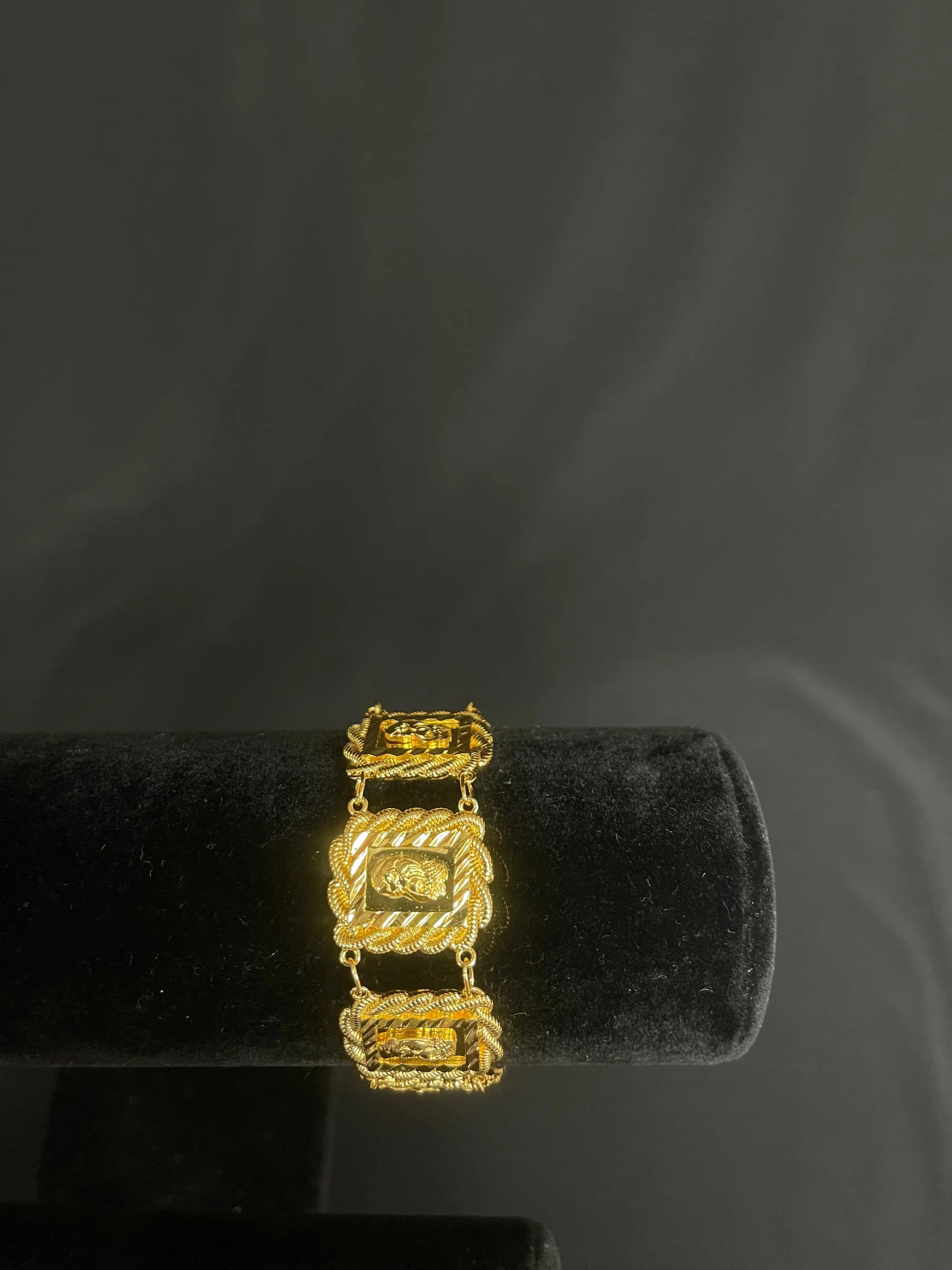 Palestinian Elegance imitated gold bracelet with intricate square and rope design on black display