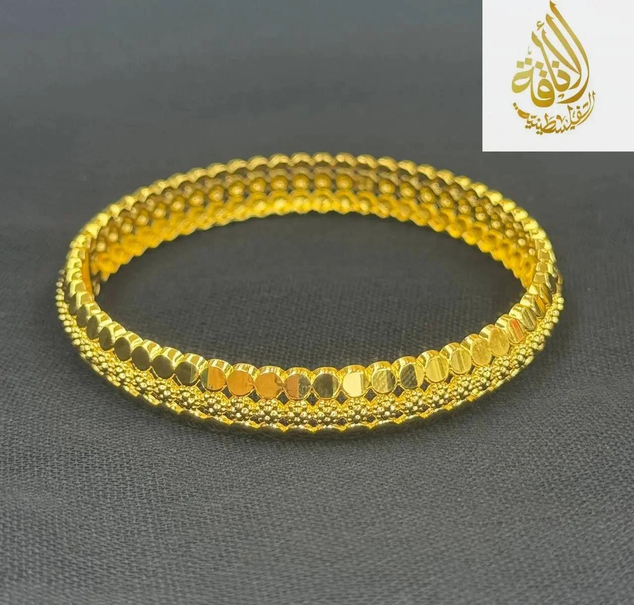 Palestinian Elegance imitation gold bangle bracelet with intricate textured design in bright gold tone