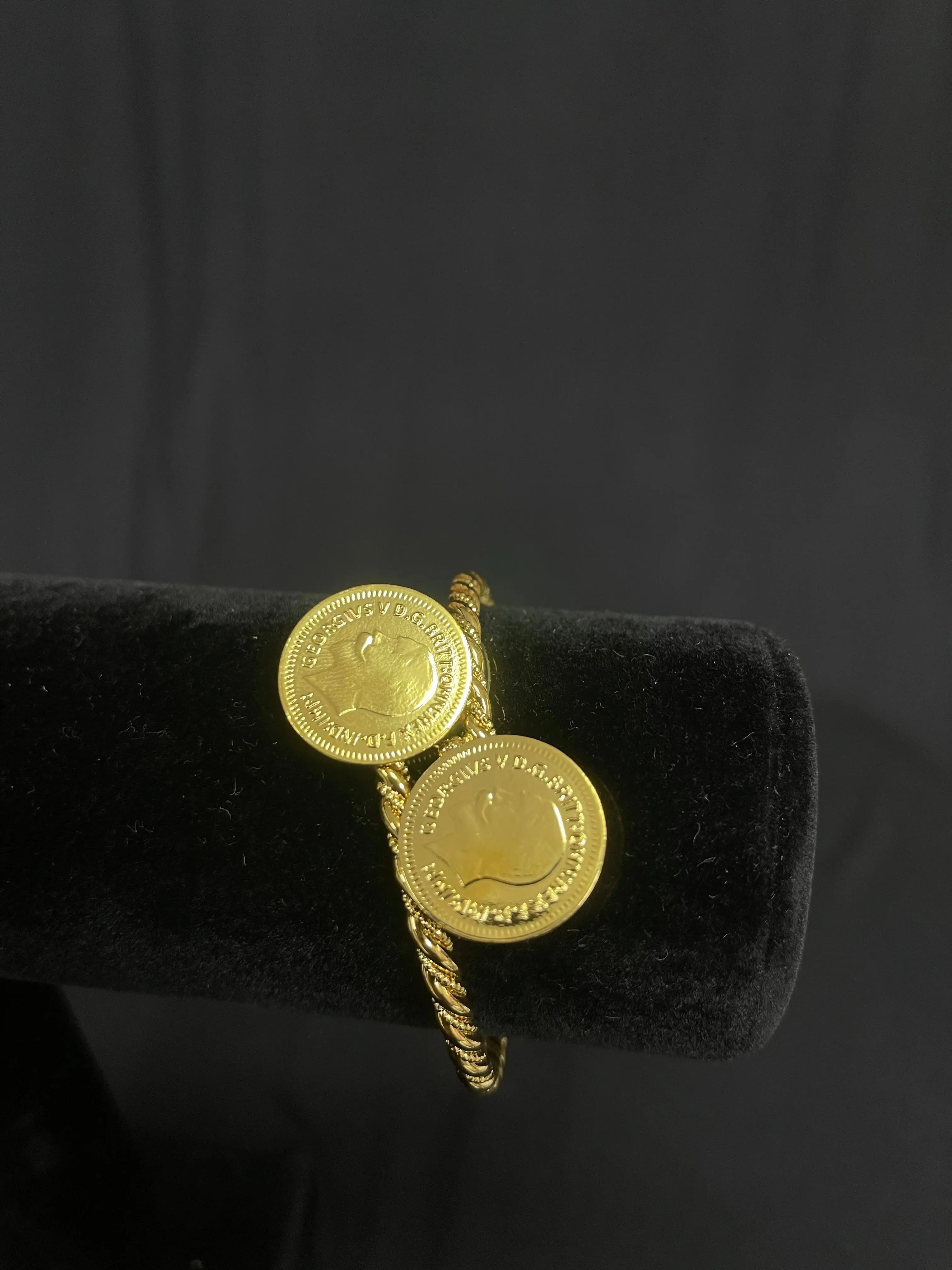Gold Palestinian coin bracelet with imitated gold coins on a twisted band by Palestinian Elegance