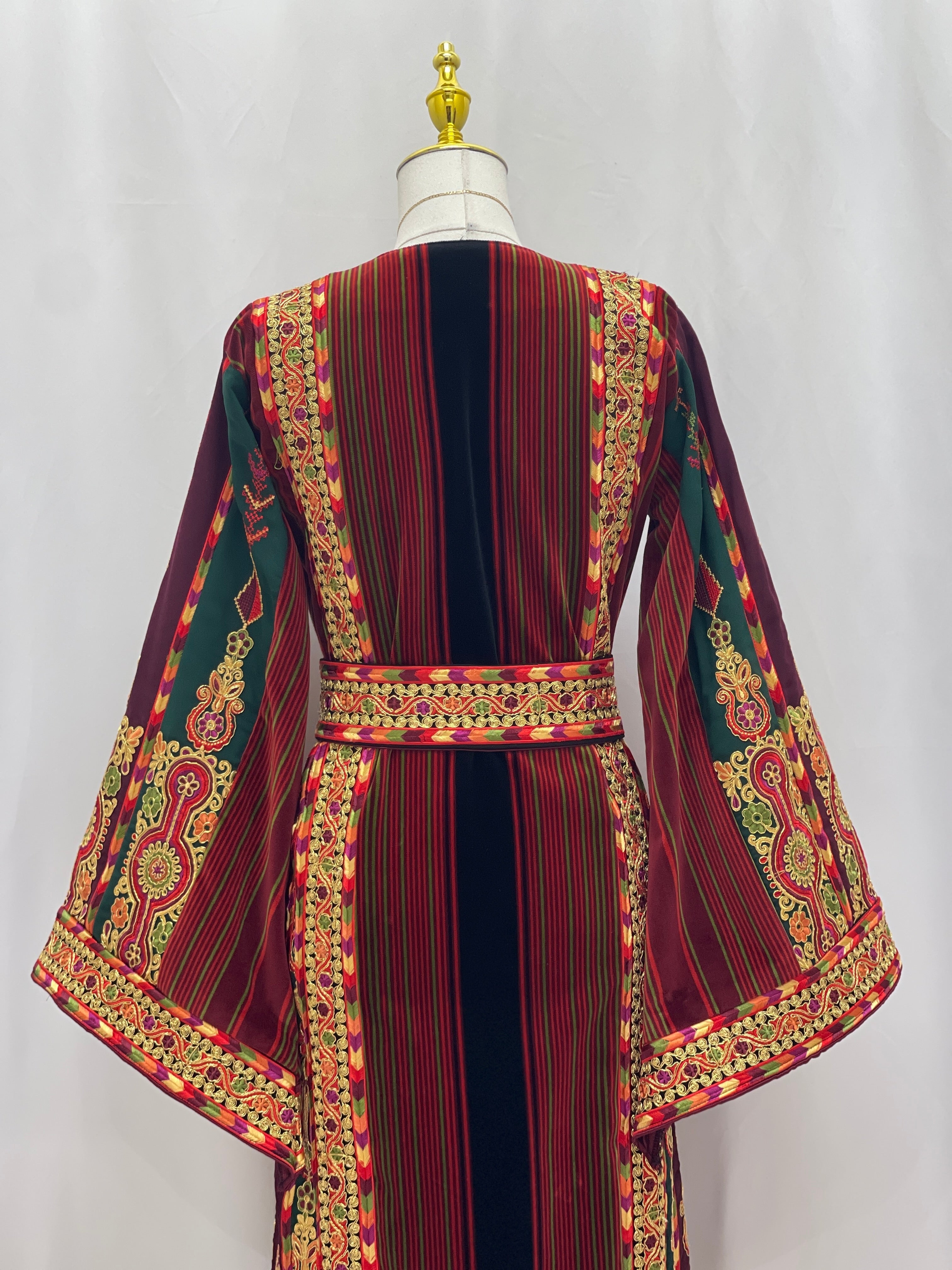 Palestinian Velvet Malaka Embroidered Thobe with colorful embroidery and striped fabric on mannequin back view