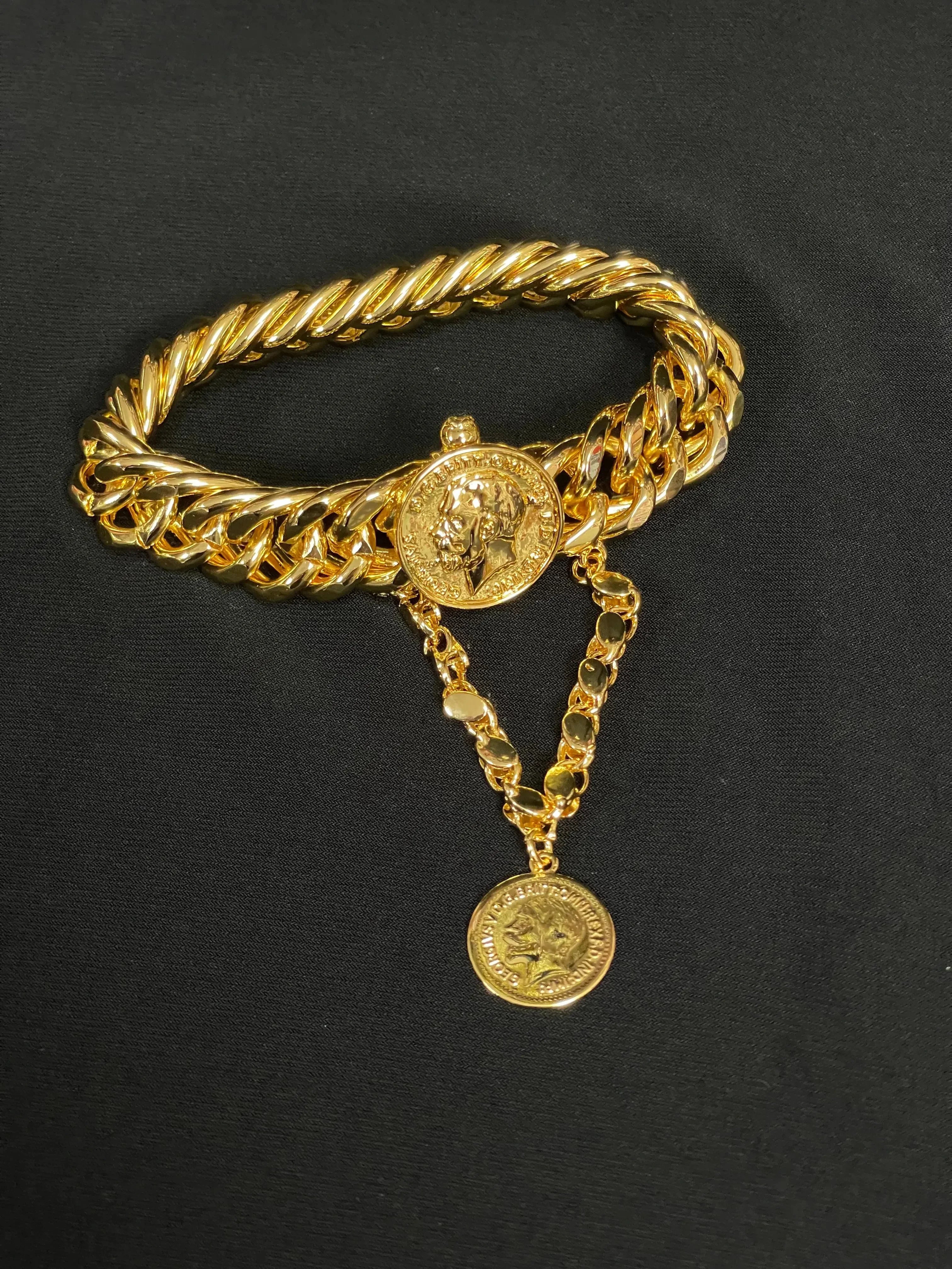 Palestinian Elegance imitated gold chain bracelet with coin charm and twisted link design on black background