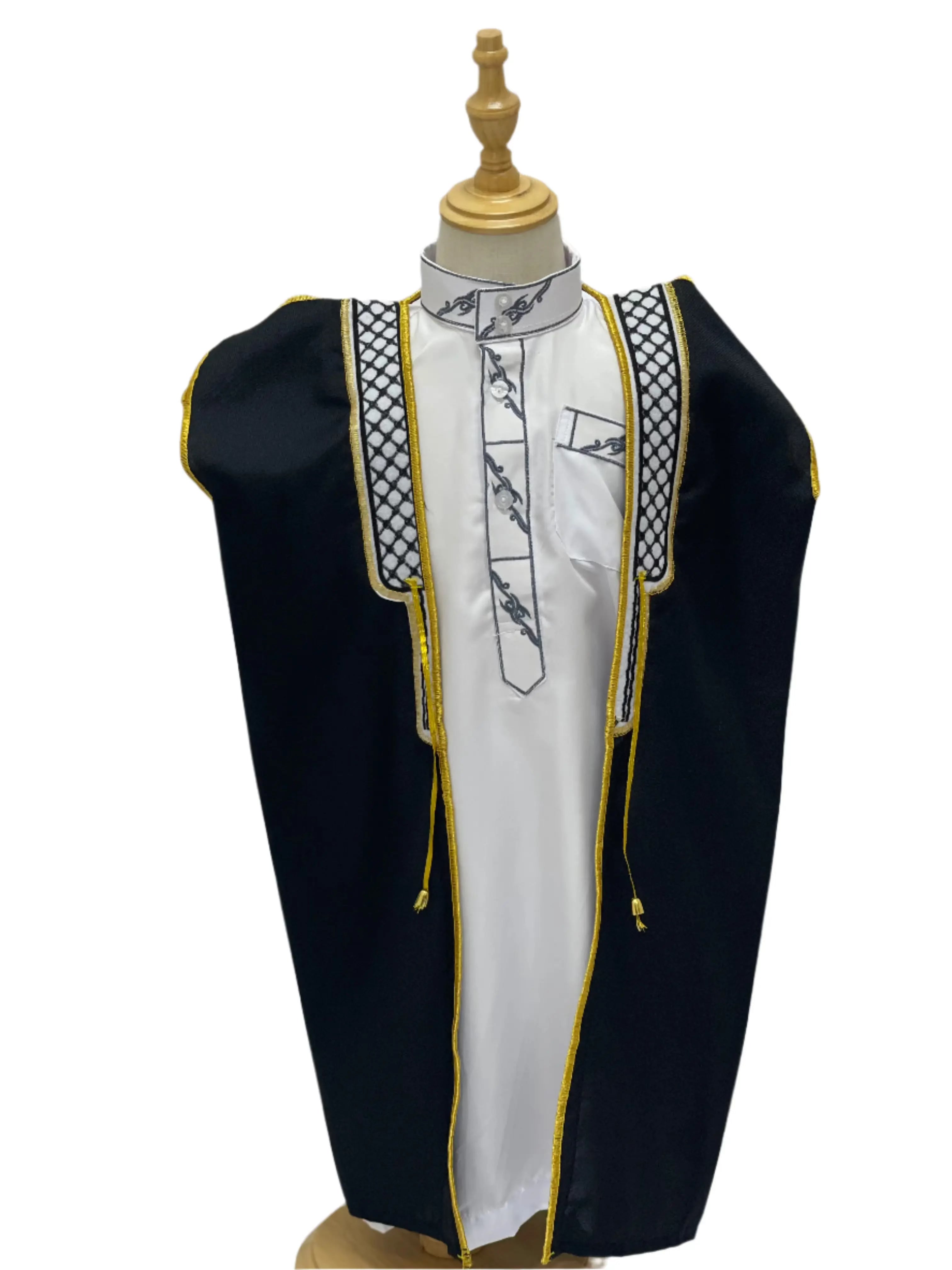 Kids Kuffiyeh Bisht by Palestinian Elegance in black with gold trim over white traditional attire