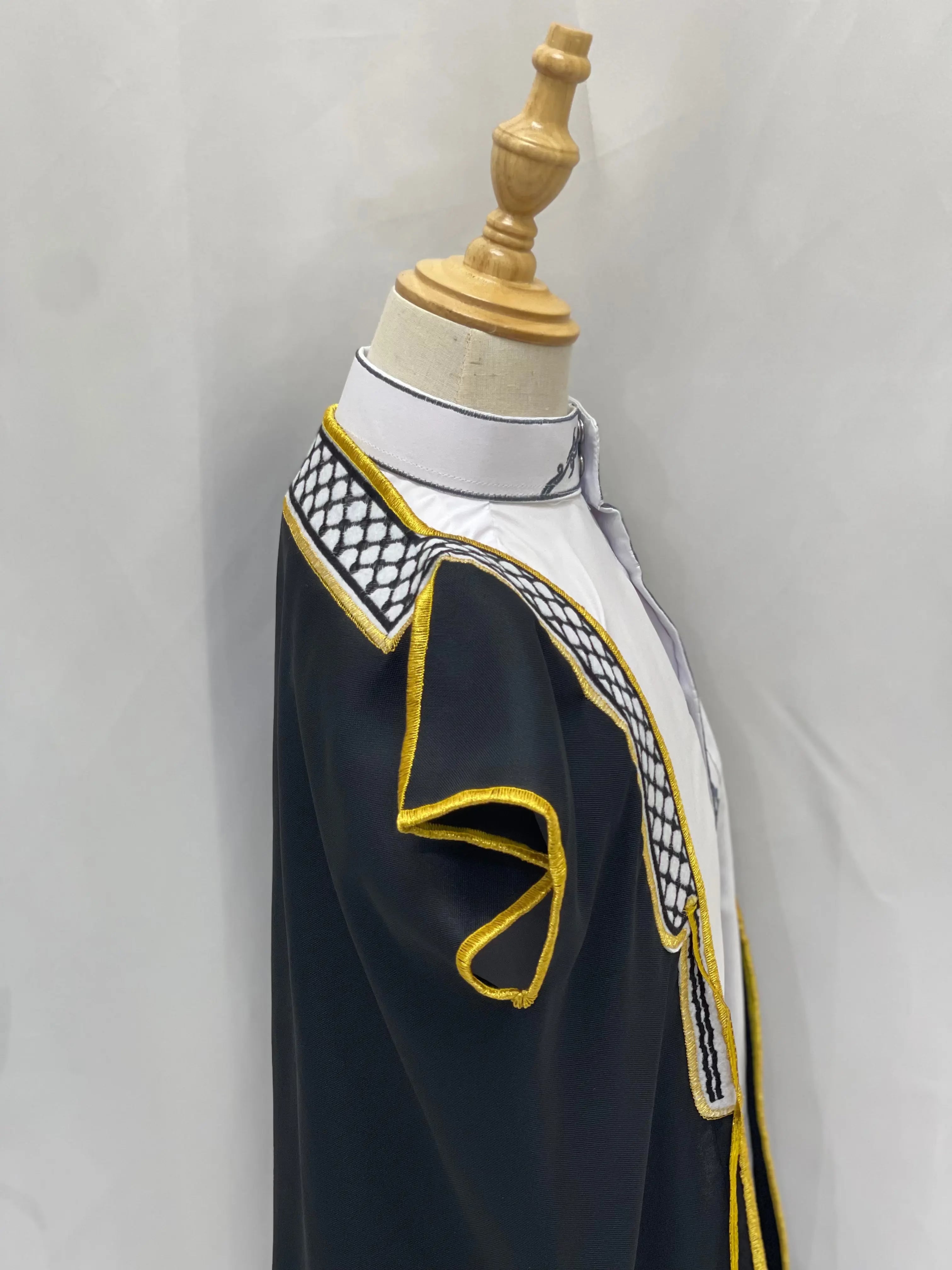 Palestinian Elegance Kids Kuffiyeh Bisht black with white and gold trim on a mannequin