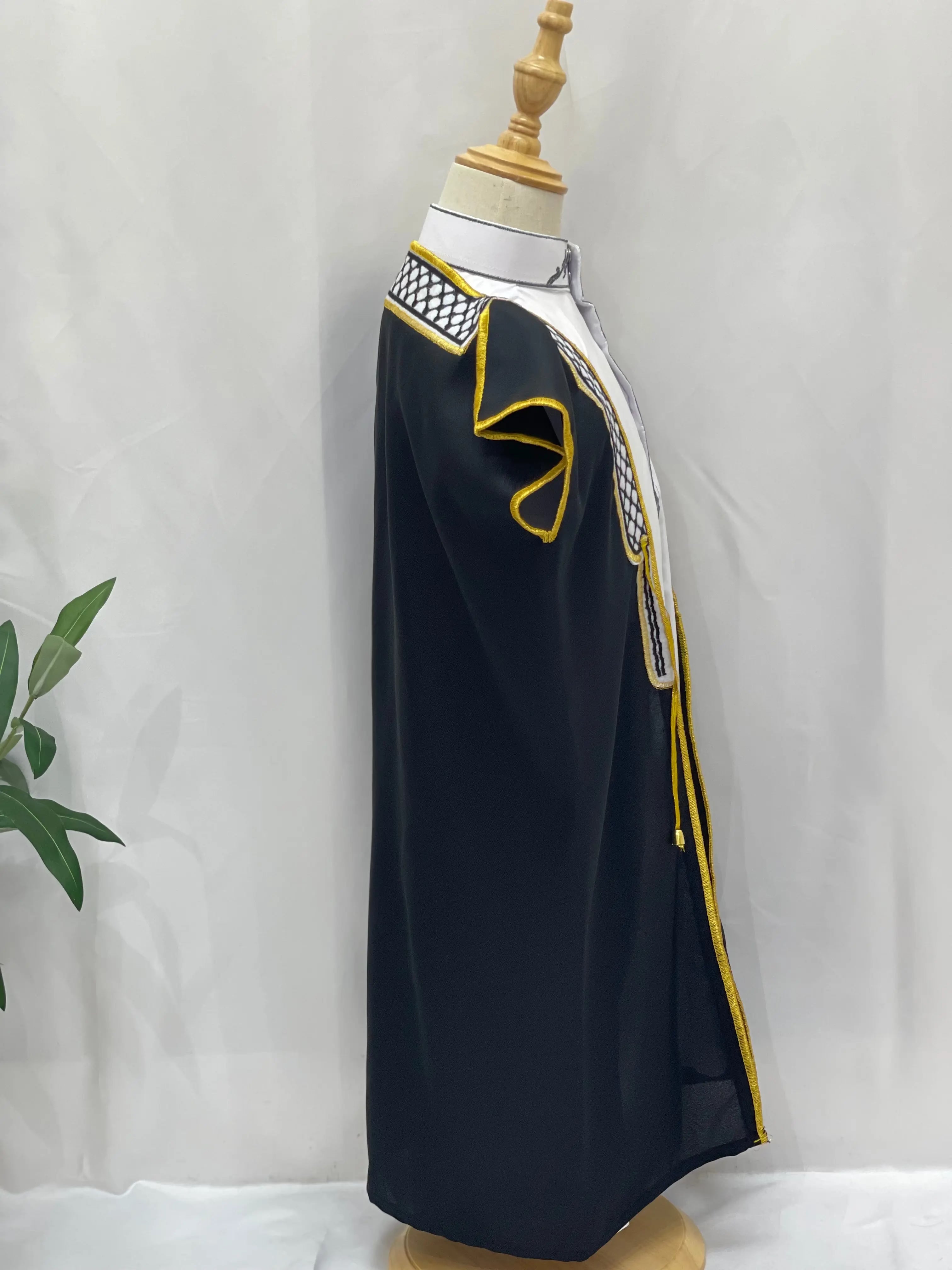 Palestinian Elegance Kids Kuffiyeh Bisht in black with yellow trim and traditional embroidery on a mannequin