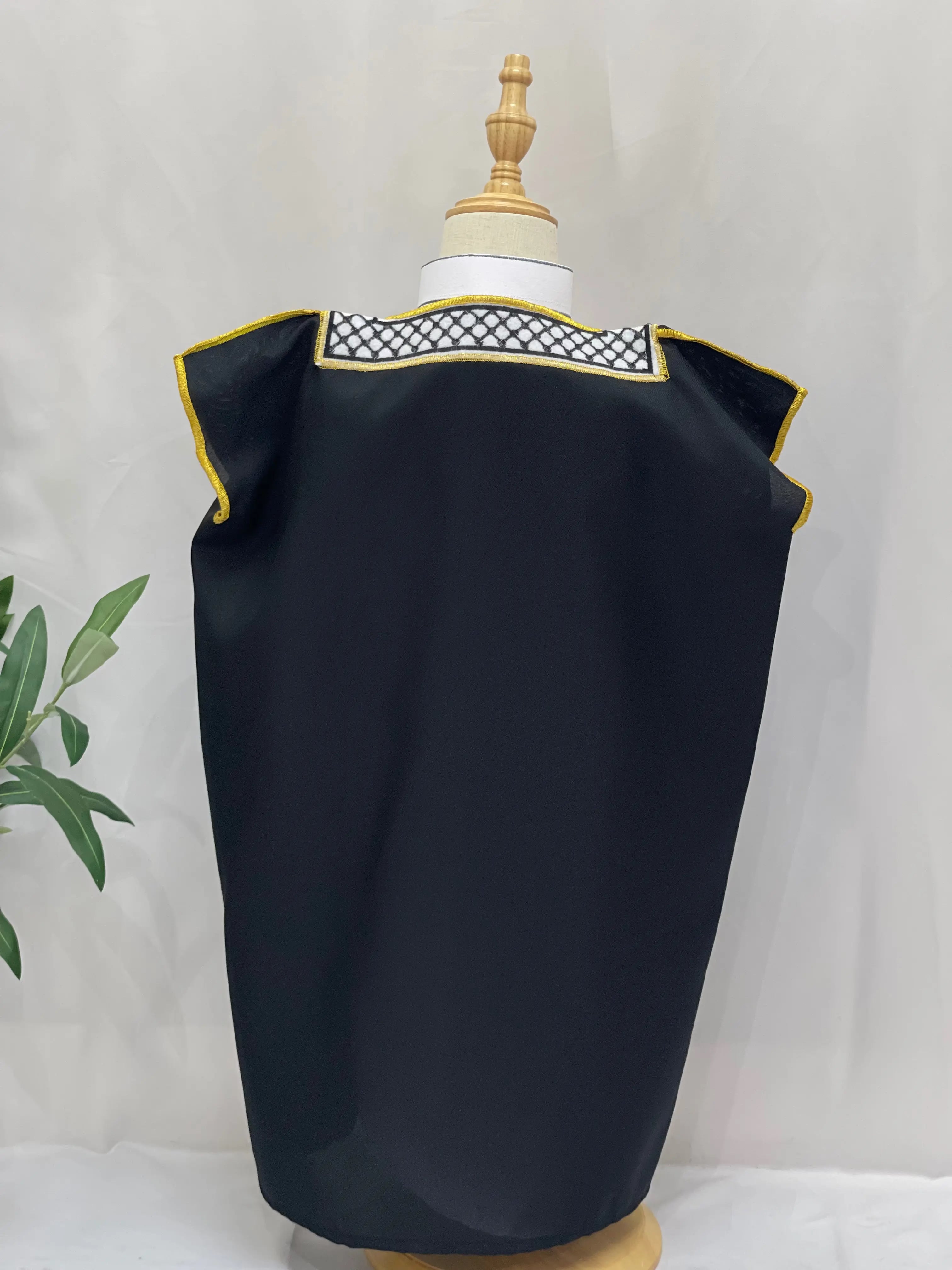 Palestinian Elegance Kids Kuffiyeh Bisht in black with gold trim displayed on a mannequin