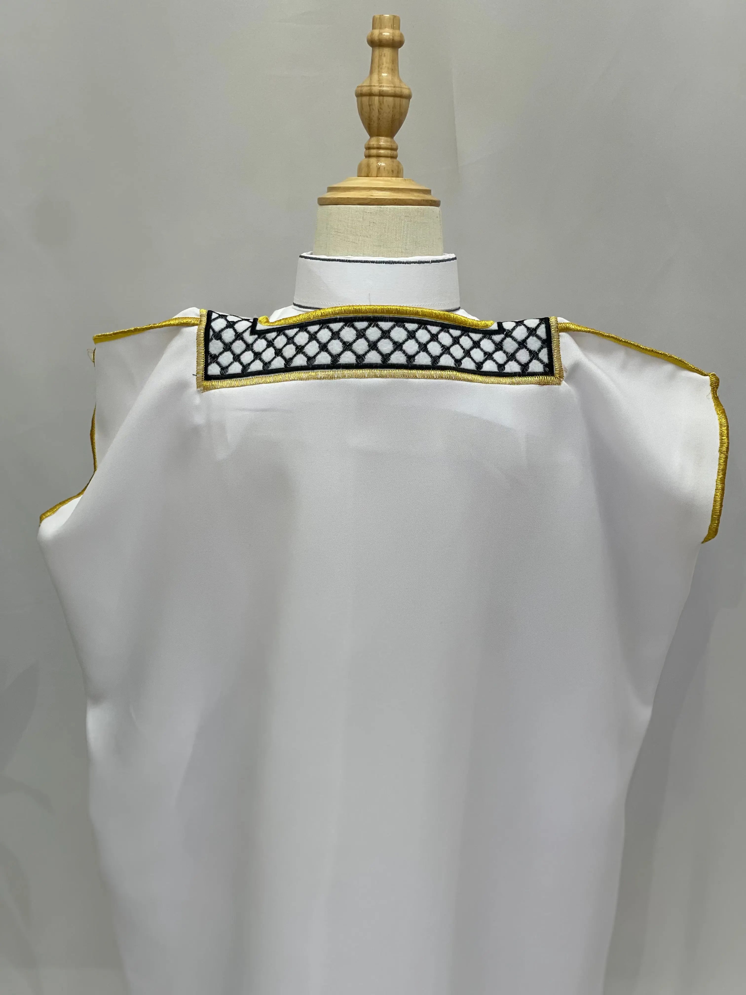 White Kids Kuffiyeh Bisht with black and white embroidered neckline and gold trim by Palestinian Elegance