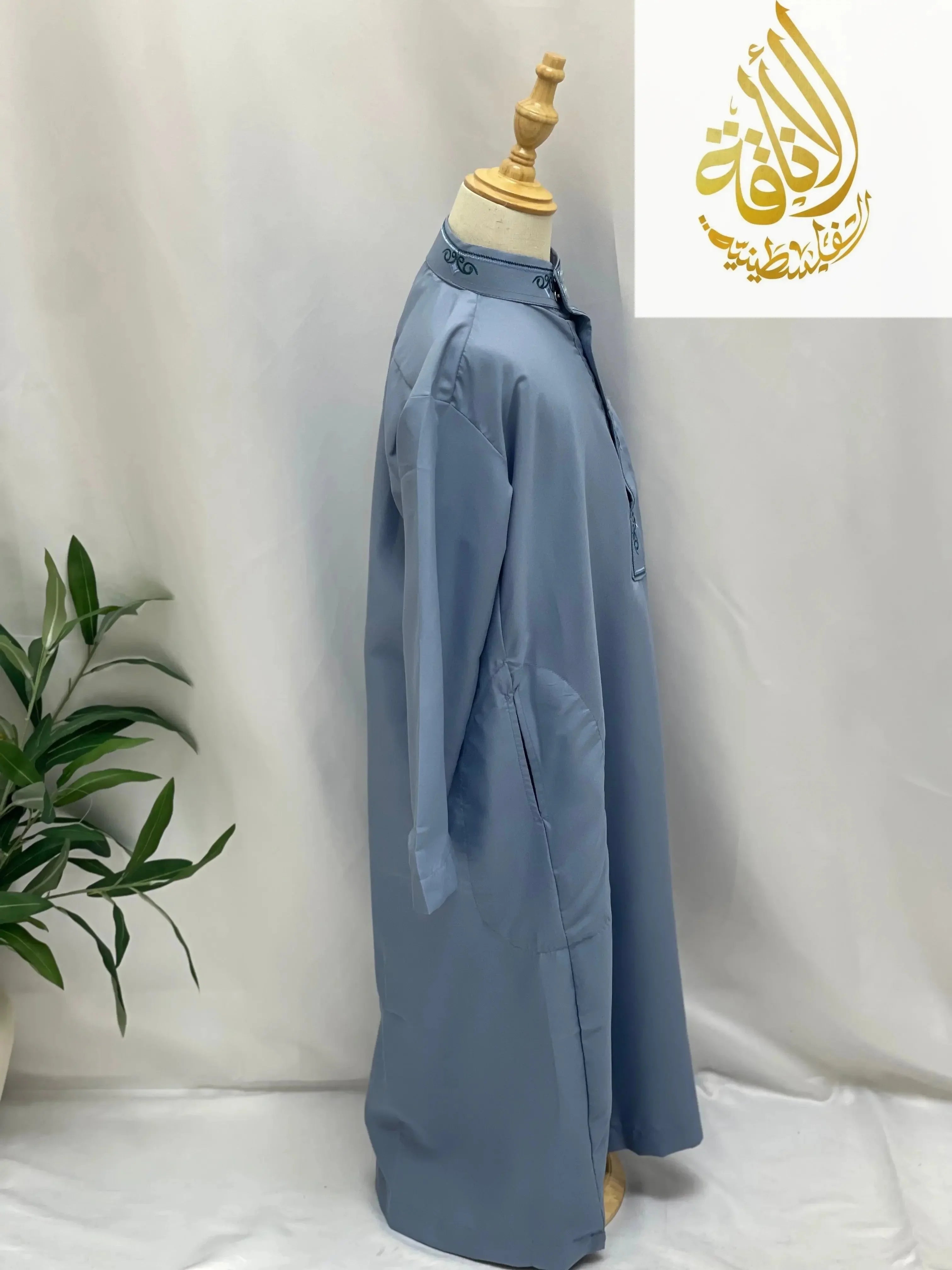 Palestinian Elegance kids embroidered thobe in light blue on mannequin with detailed collar embroidery