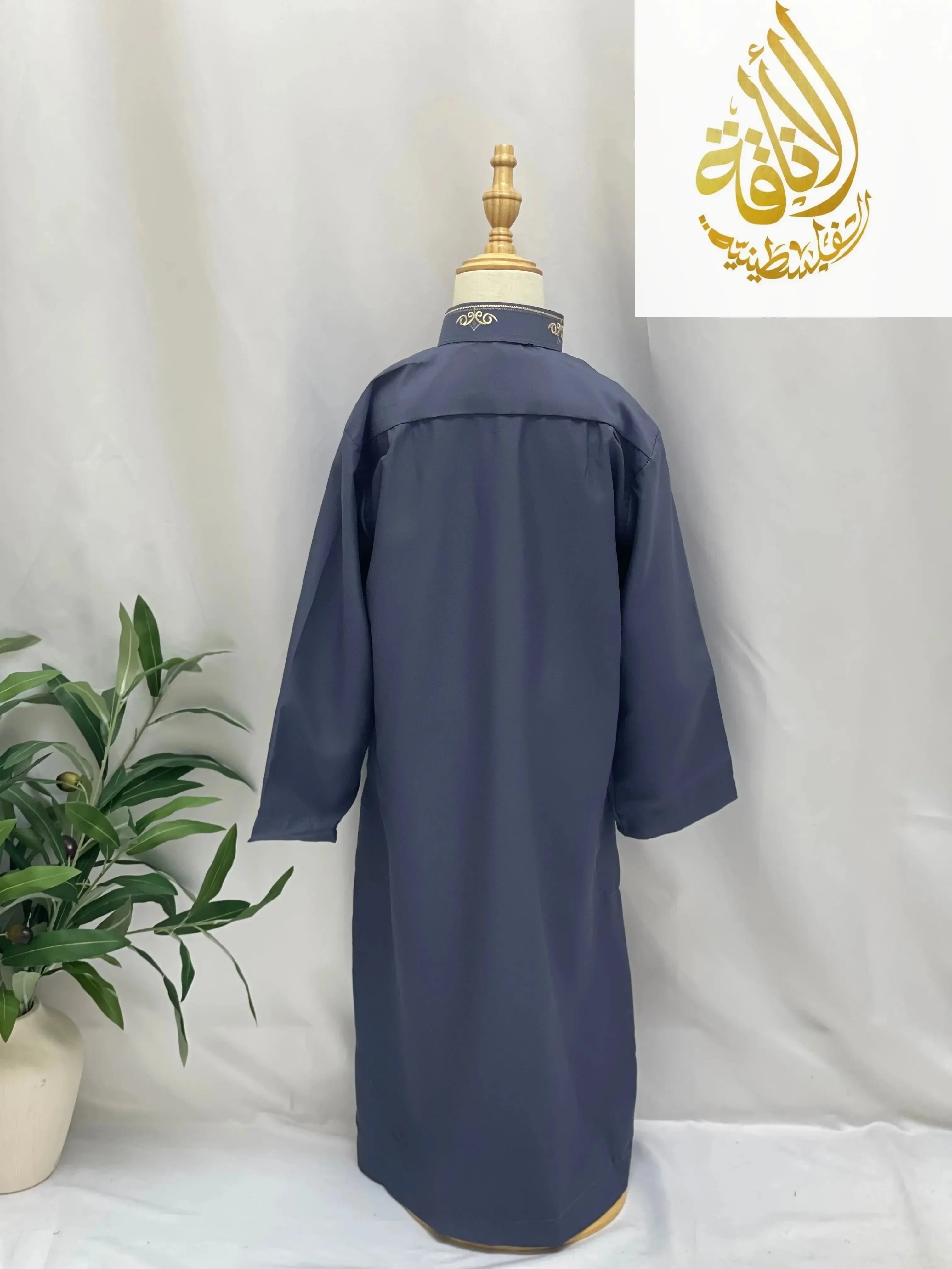 Back view of navy blue kids embroidered thobe from Palestinian Elegance displayed on mannequin