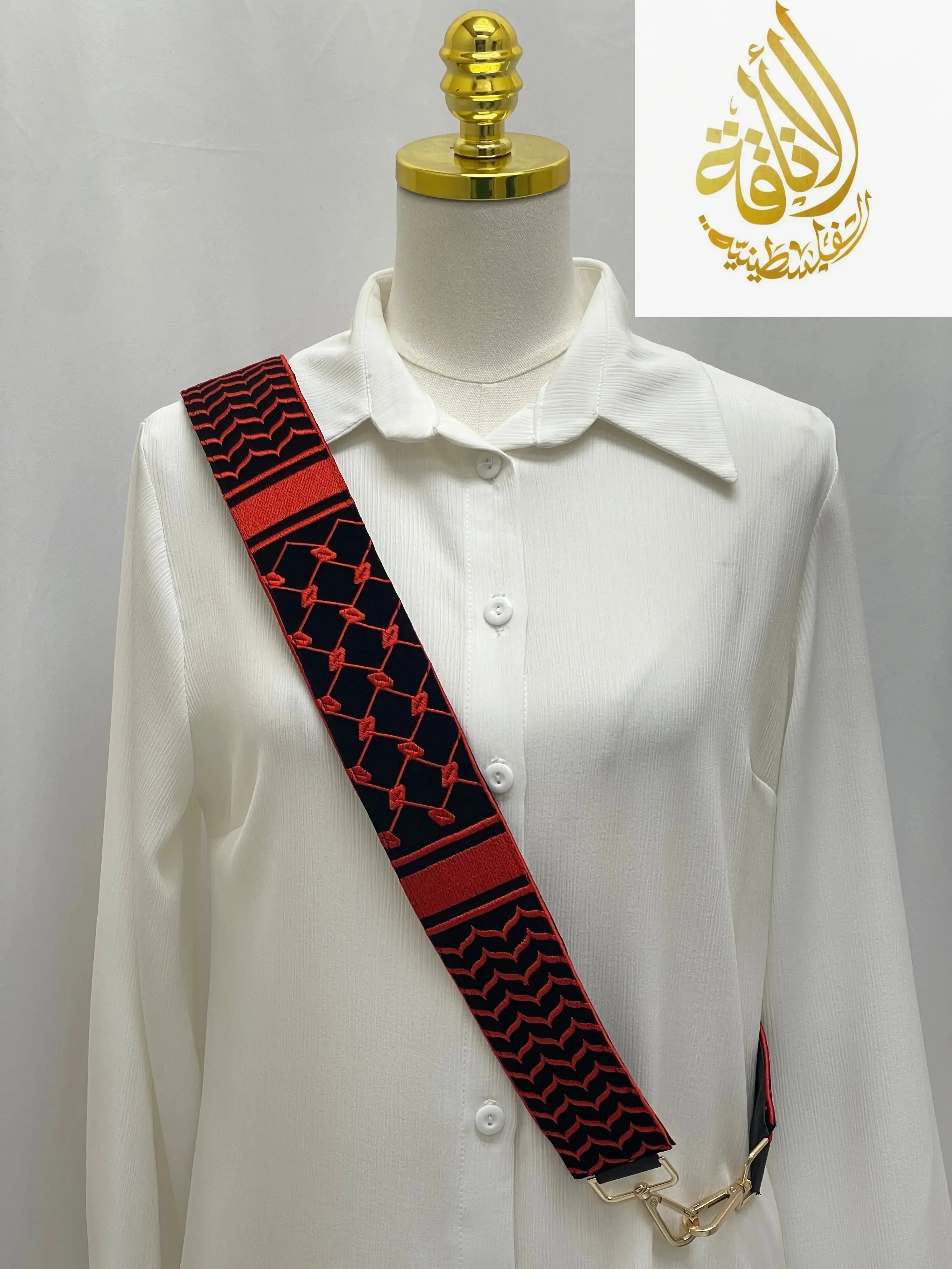 Kuffia Embroidered Purse Strap in red and black by Palestinian Elegance on white shirt mannequin