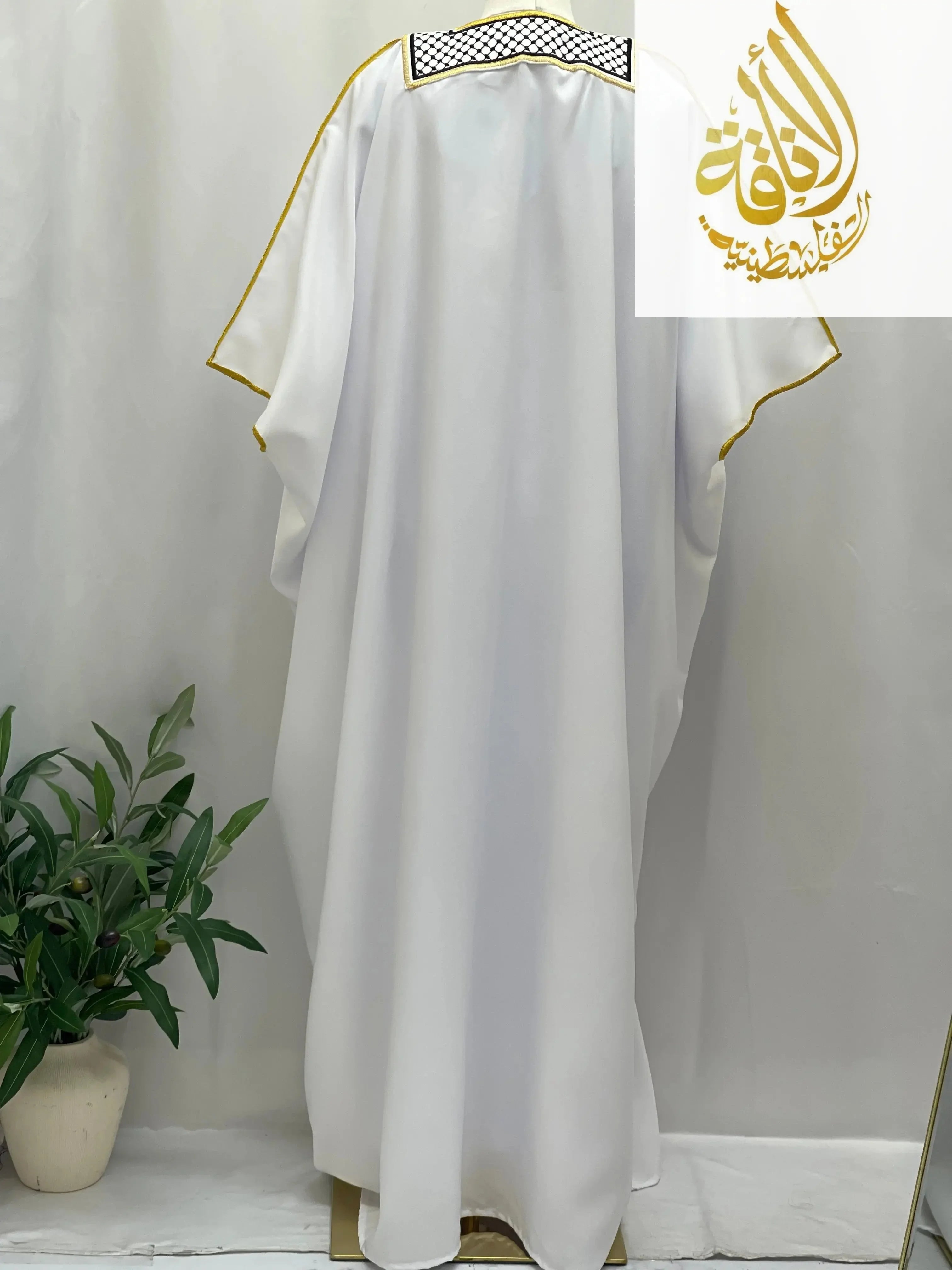Men thobe with gold trim and keffiyeh detail from Palestinian Elegance keffiyeh bisht for sale