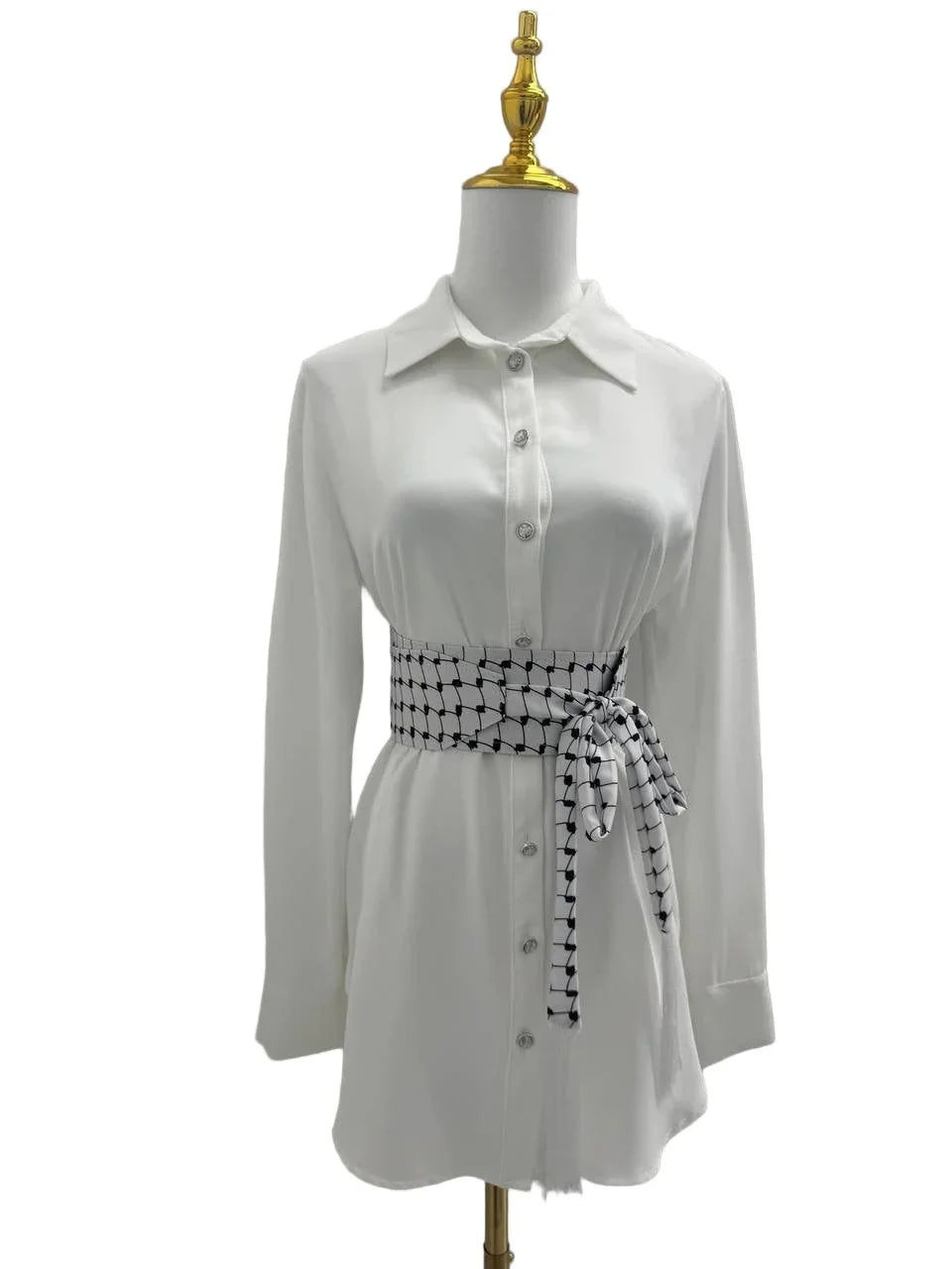 Kufiya Identity Belt in black and white, styled around a white button-up dress for a chic look
