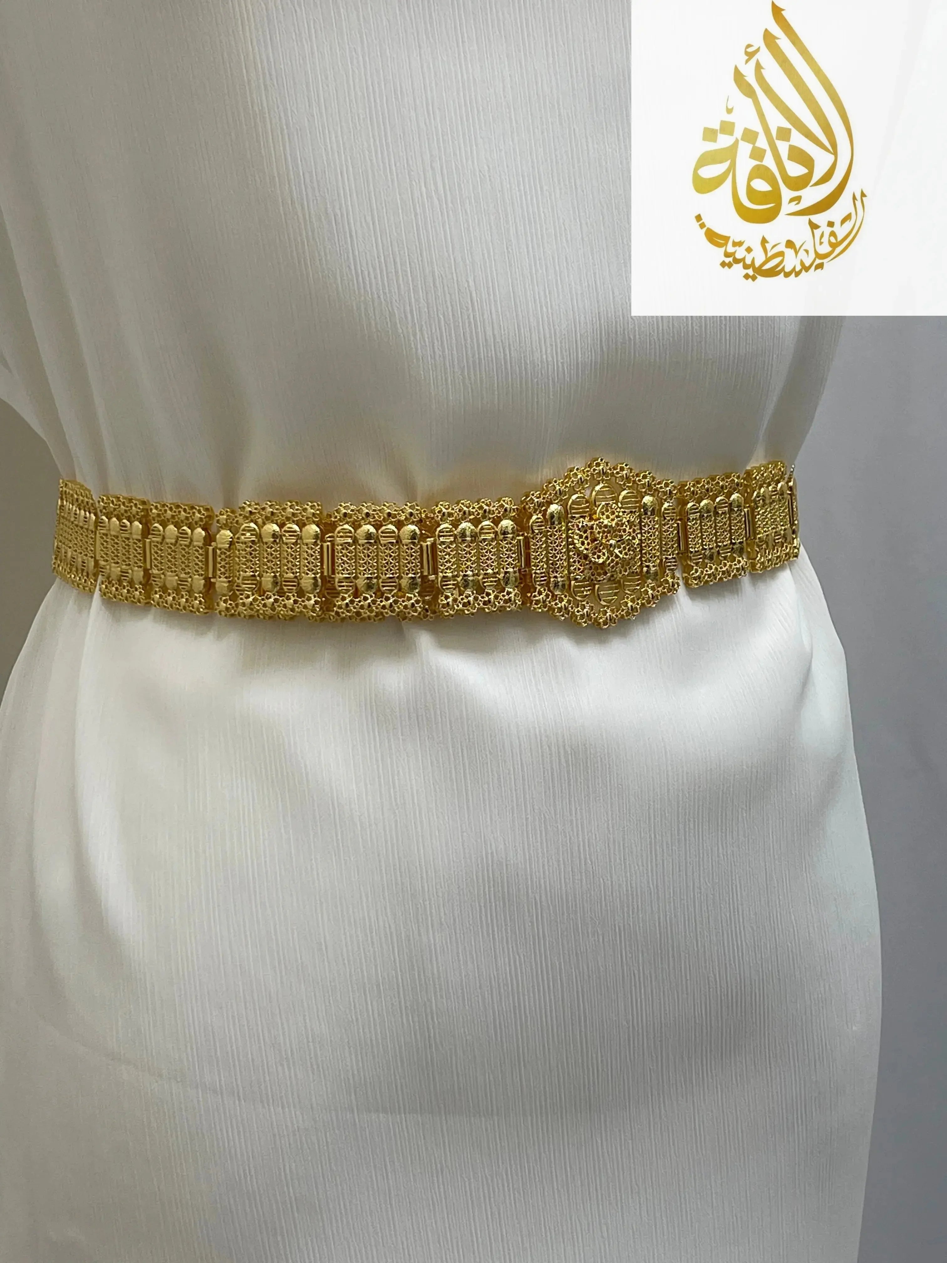 Kurdish gold style belt by Palestinian Elegance on a white dress showing intricate gold detailing