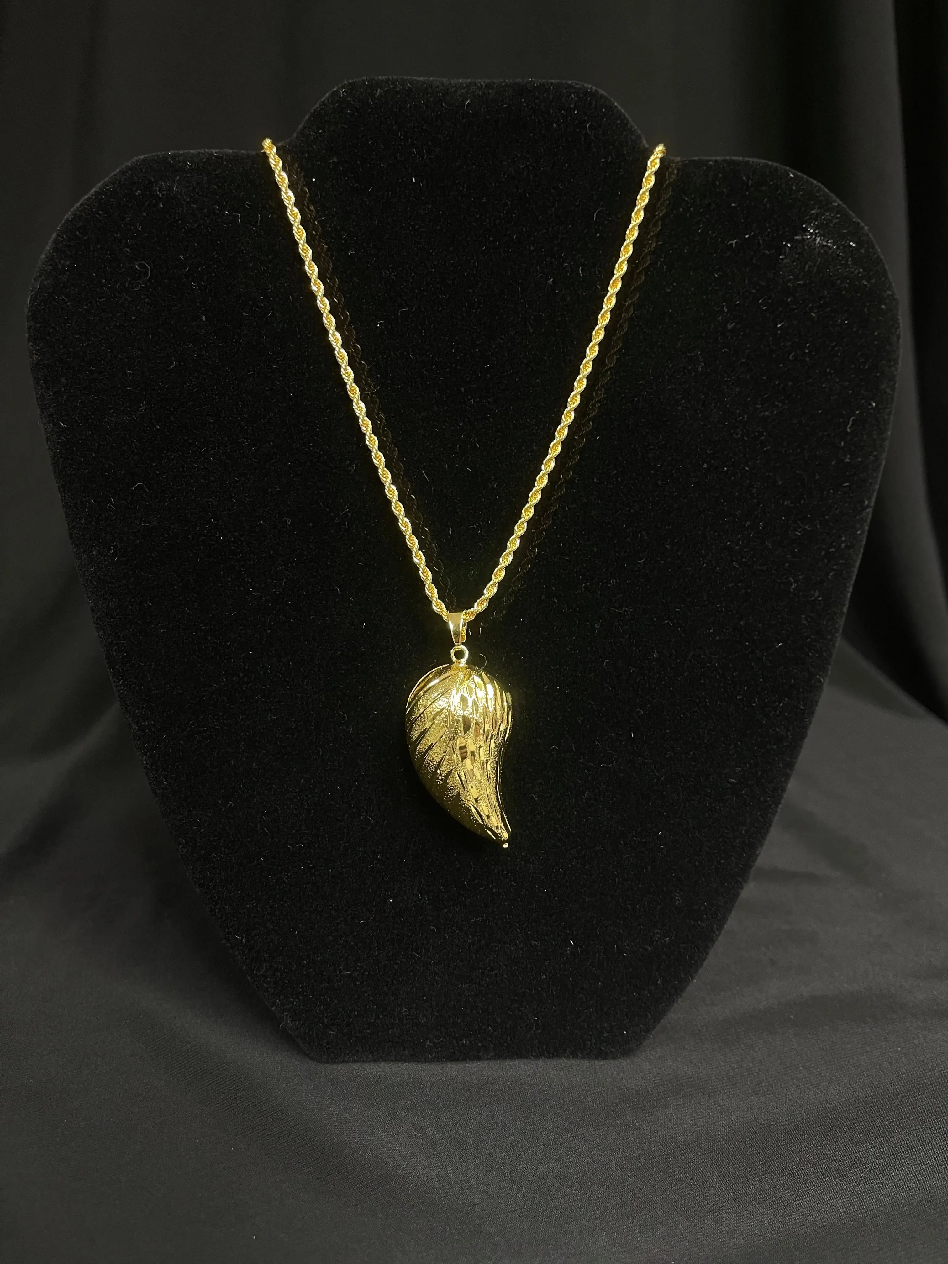 Large Almond Pendant imitated gold necklace displayed on black velvet stand by Palestinian Elegance