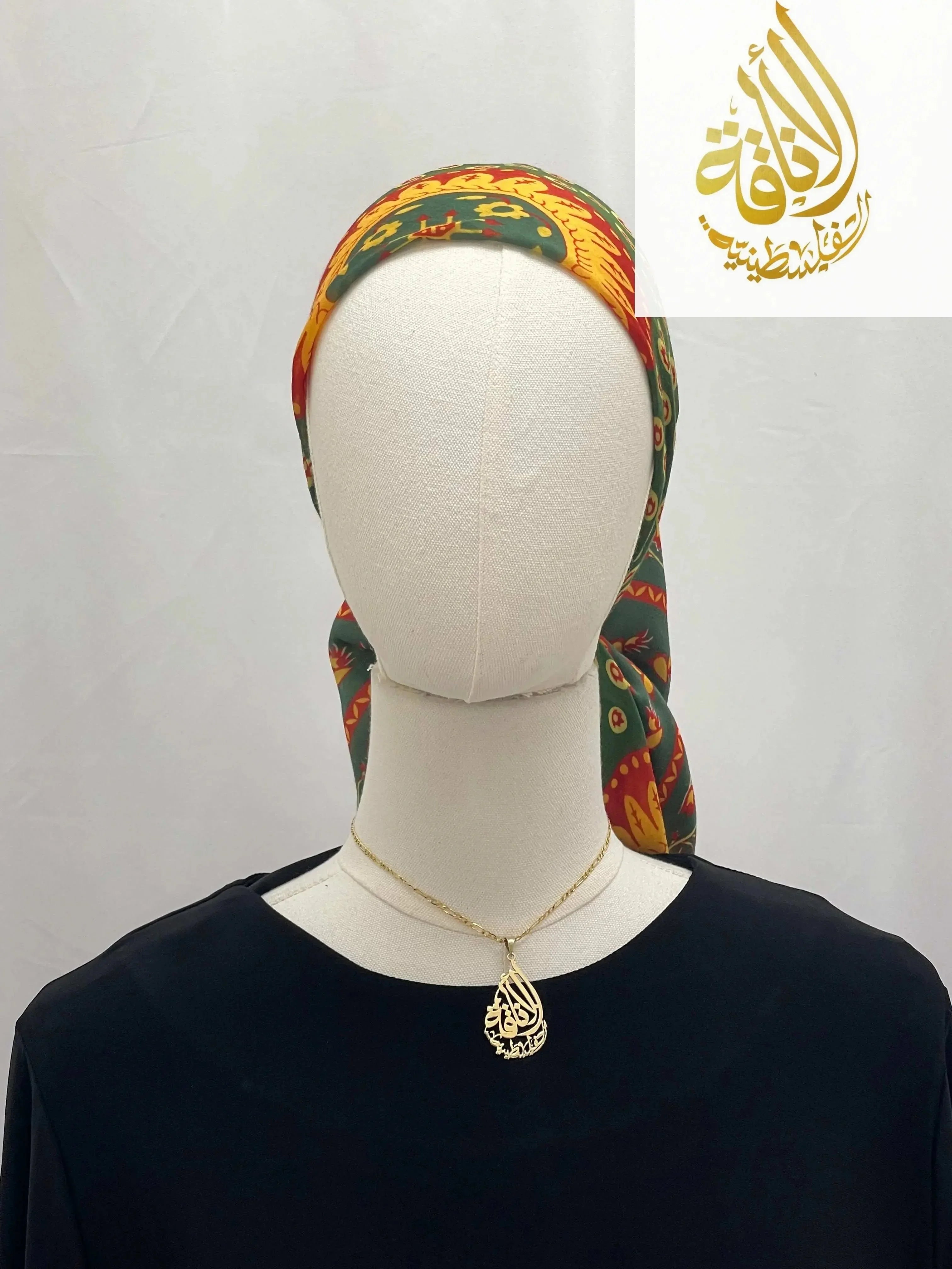 Palestinian Elegance Large Square Siti Asba hijab in green and yellow floral pattern styled on mannequin
