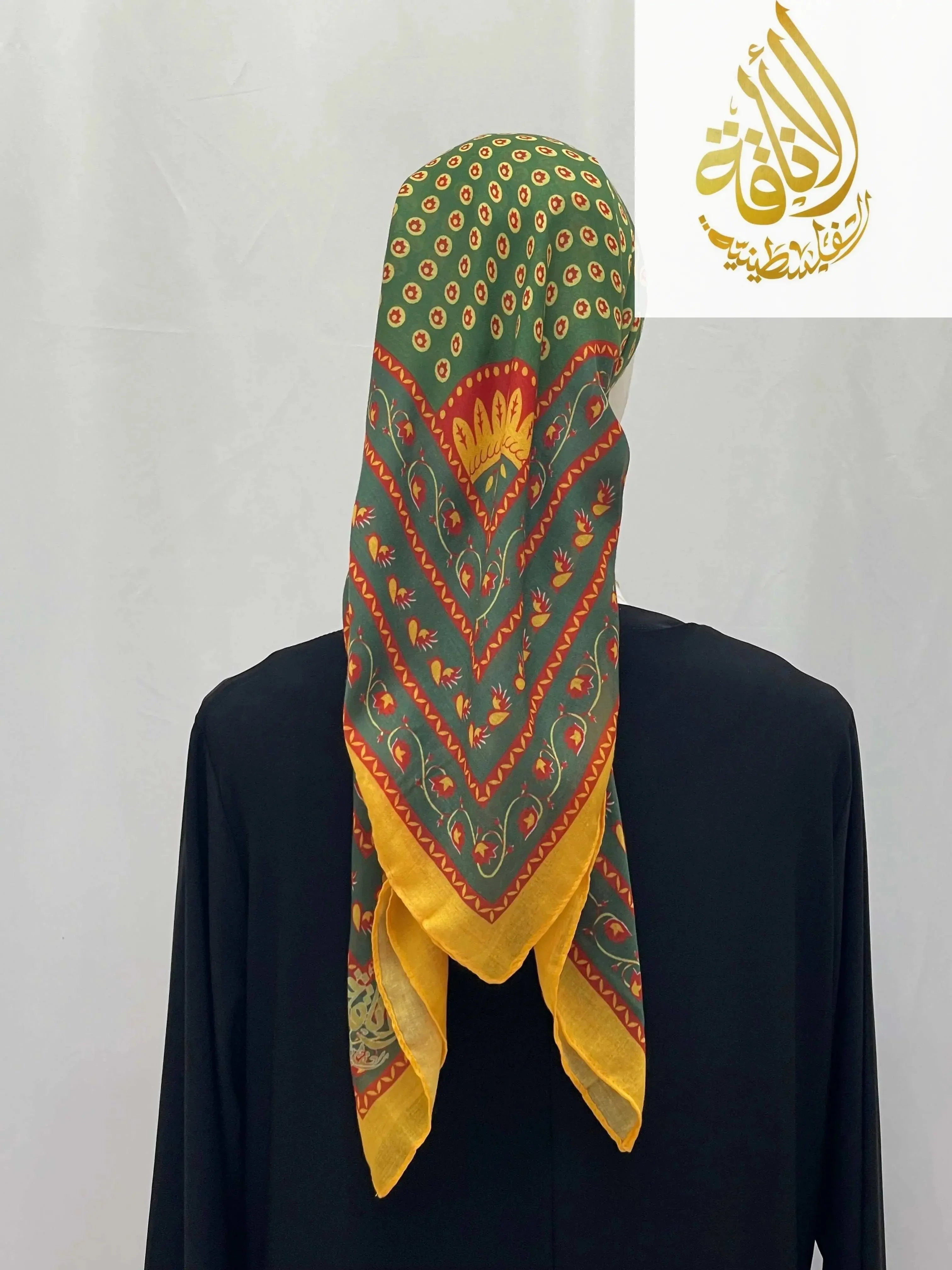 Palestinian Elegance green and yellow Large Square Siti Asba hijab with intricate patterns worn over black garment