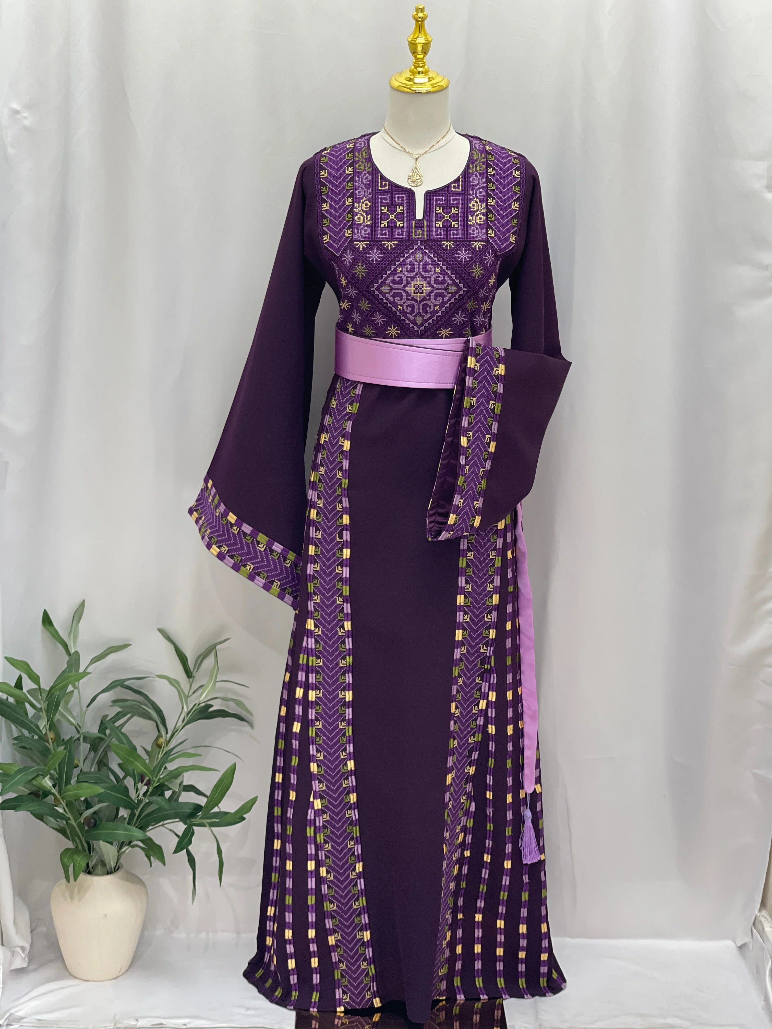 Lavender Heritage Embroidered Thobe featuring intricate designs and elegant sleeves from Palestinian Elegance