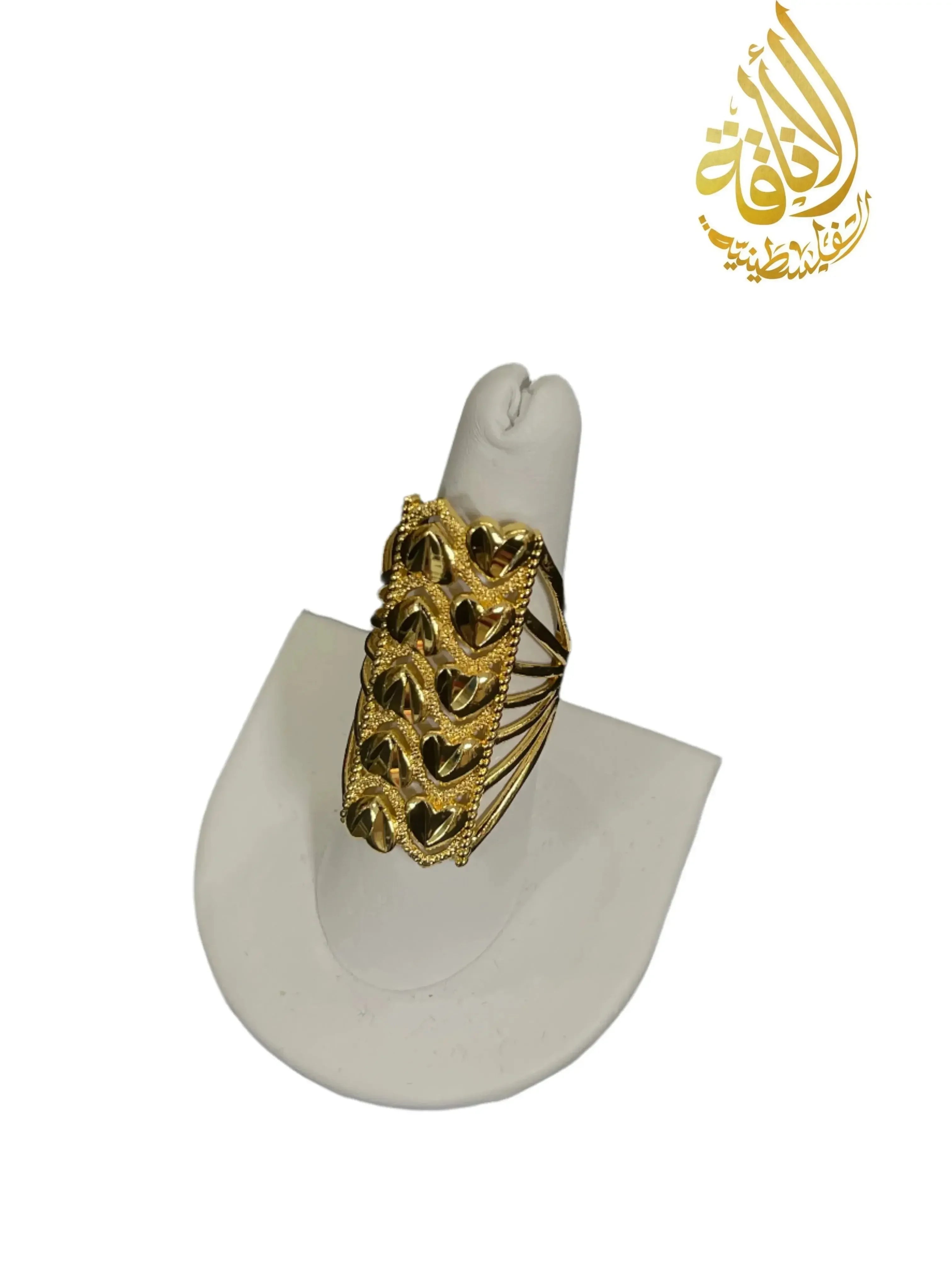Layered hearts gold ring in imitated gold by Palestinian Elegance displayed on white ring stand