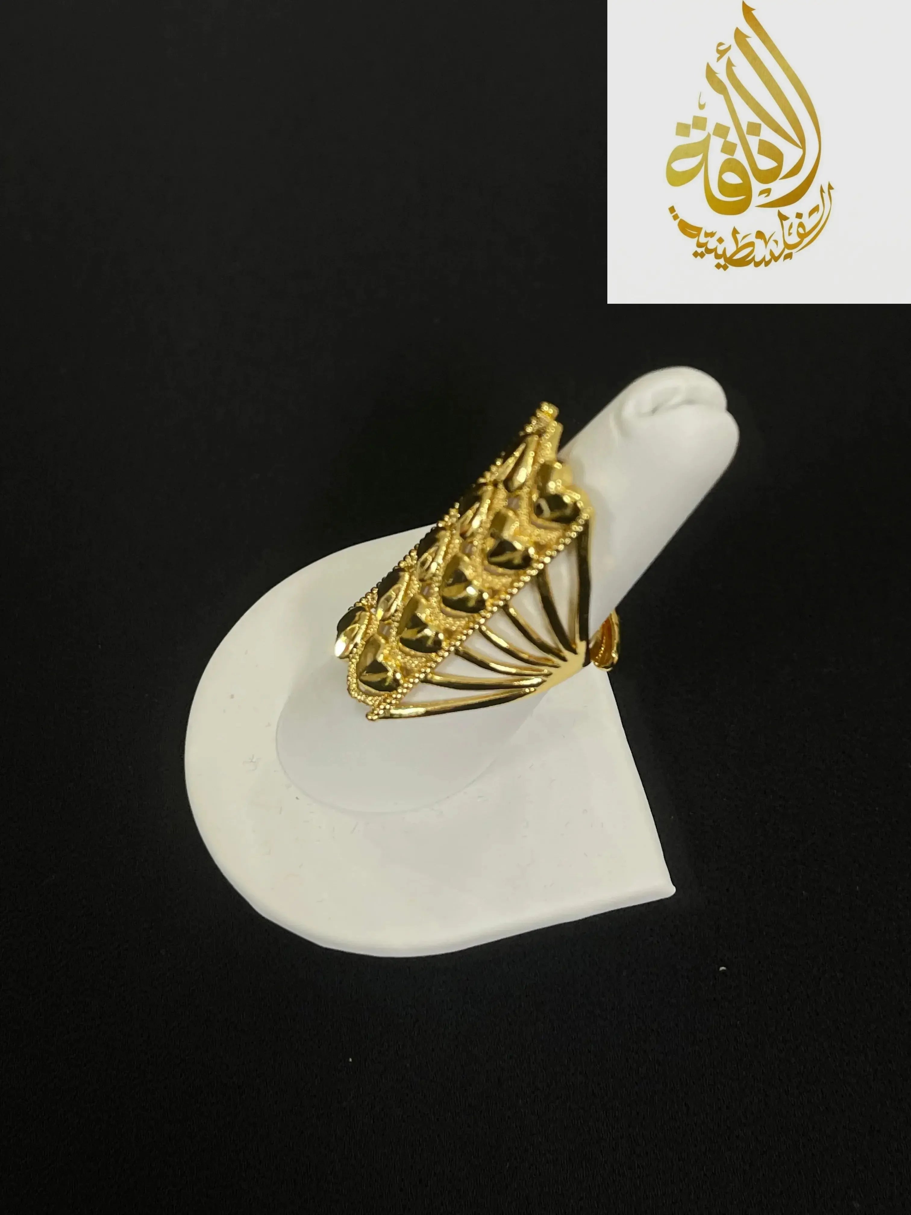 Layered hearts gold ring in imitated gold displayed on white ring holder by Palestinian Elegance