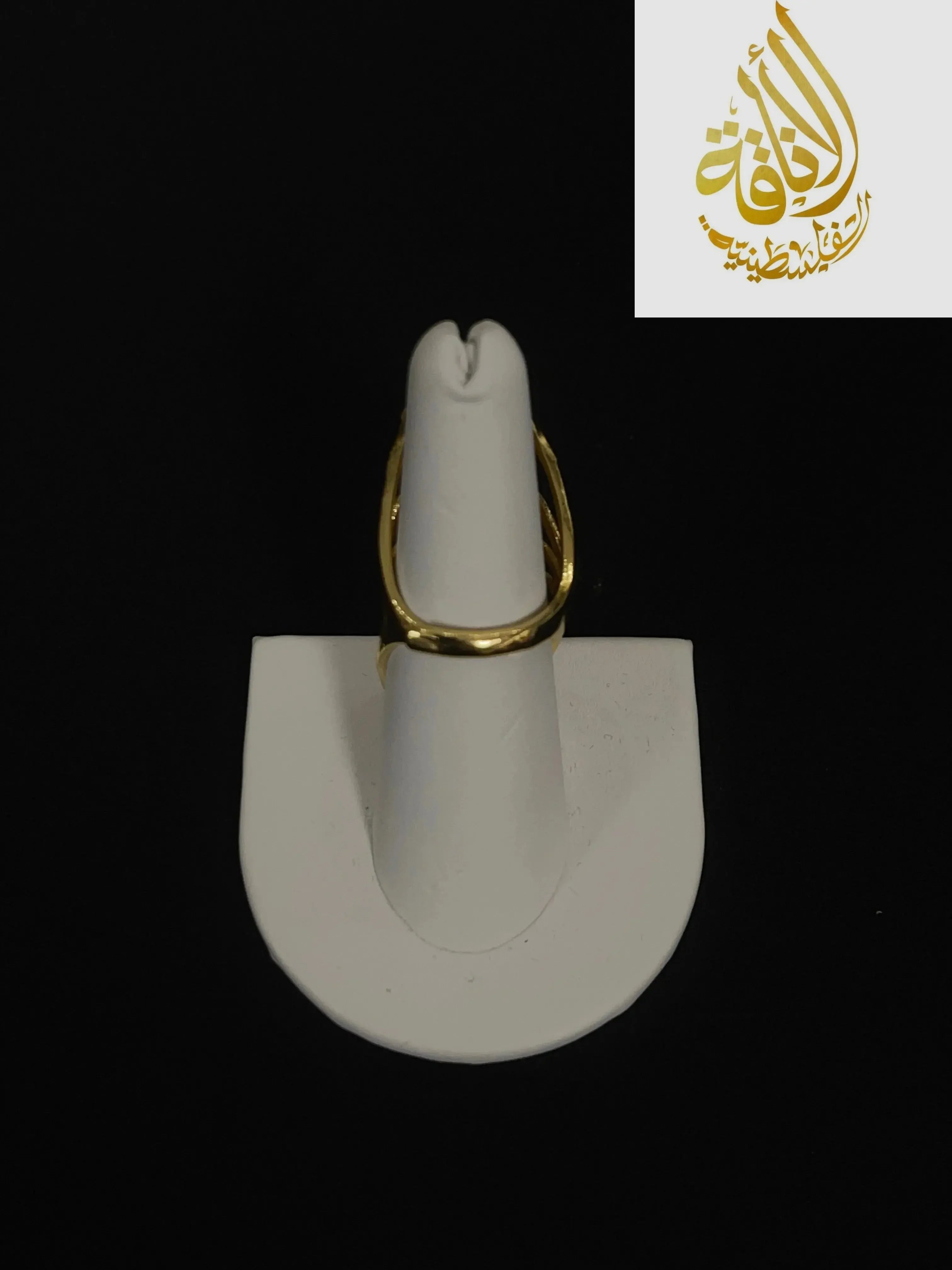 Layered hearts gold ring made of imitated gold displayed on white stand by Palestinian Elegance