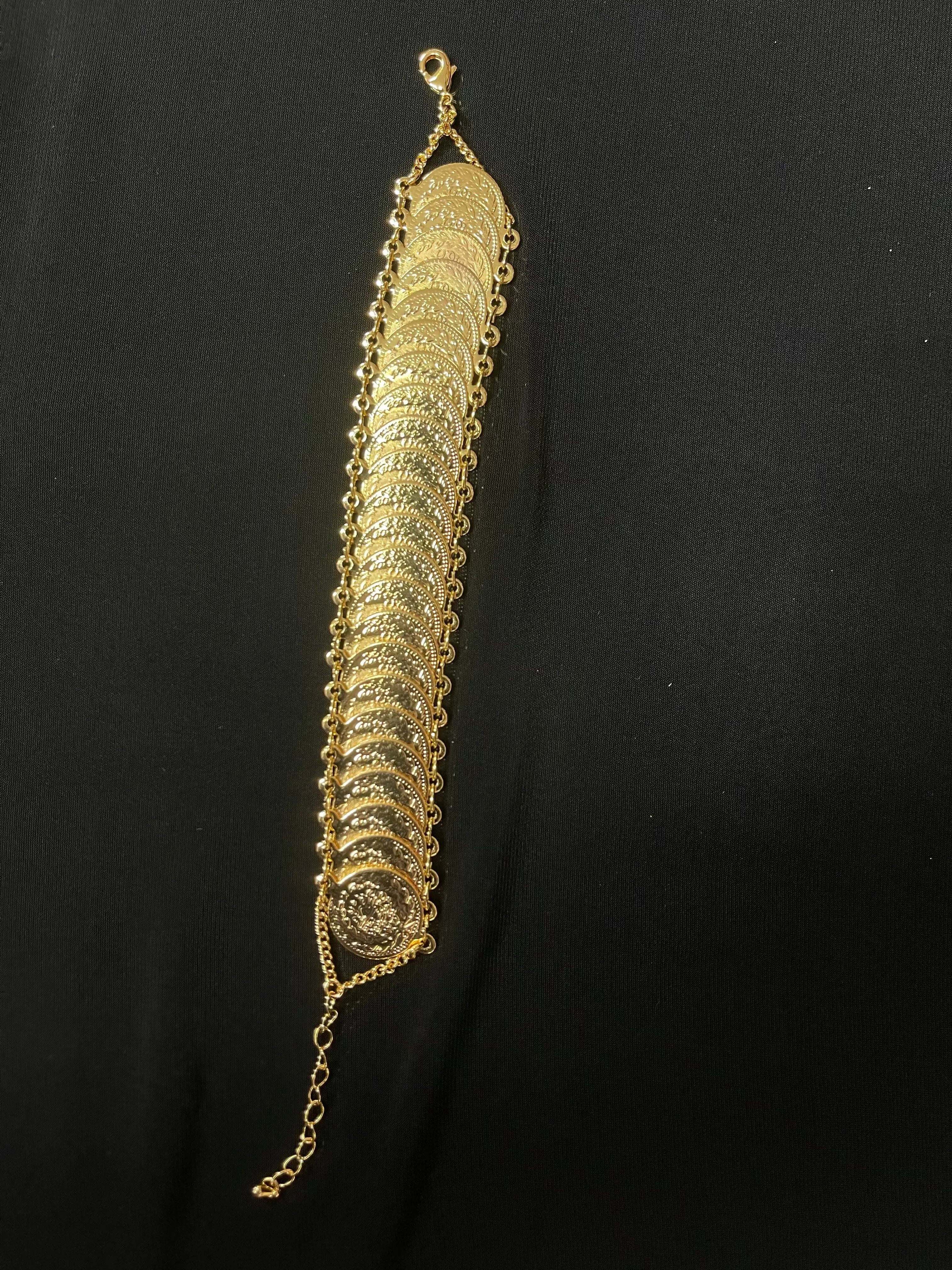 Gold imitated with palestine traditional design bracelet by Palestinian Elegance on black background