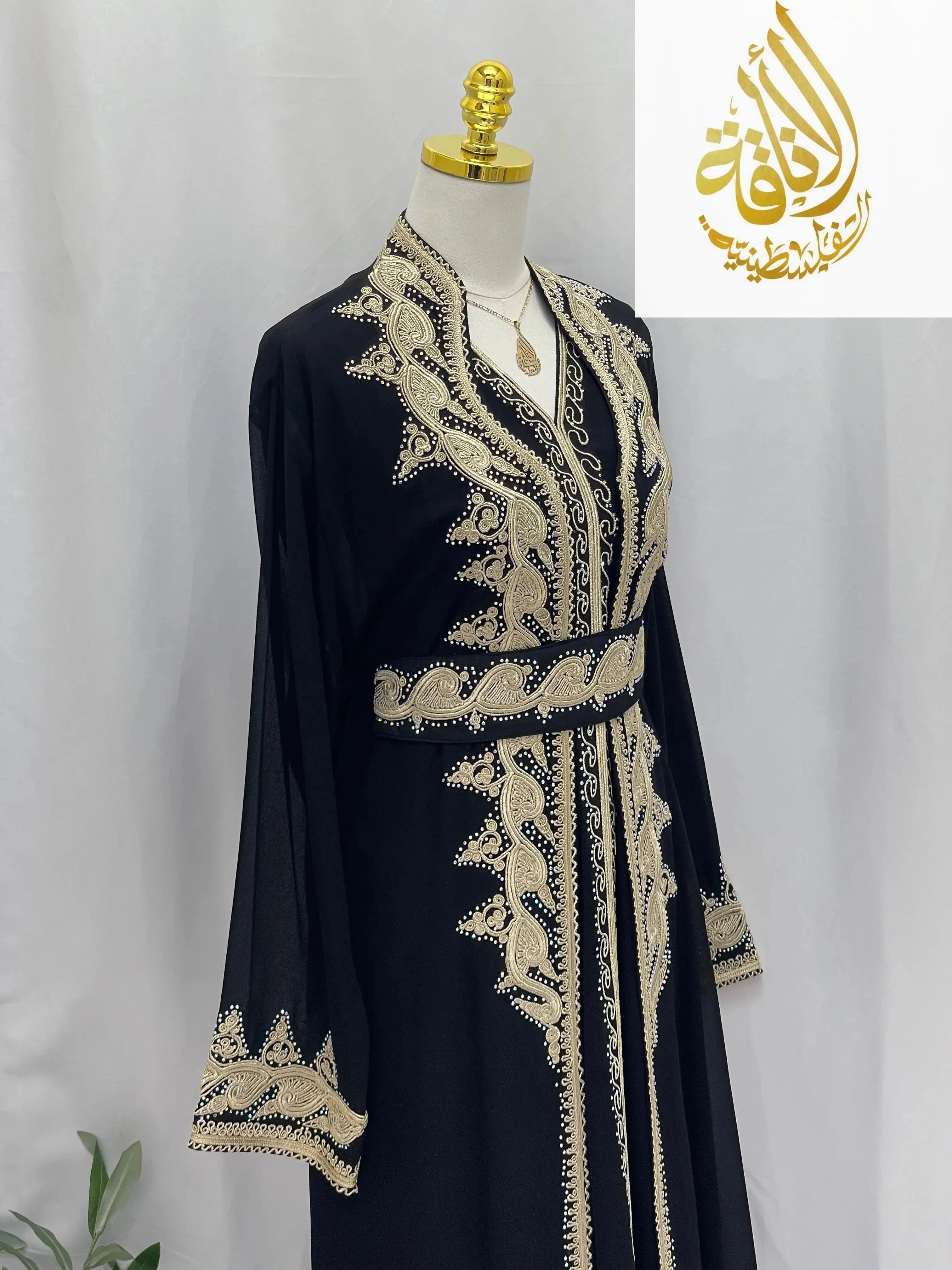 Black luxurious Alamera kaftan with intricate beige embroidery and matching belt from Palestinian Elegance